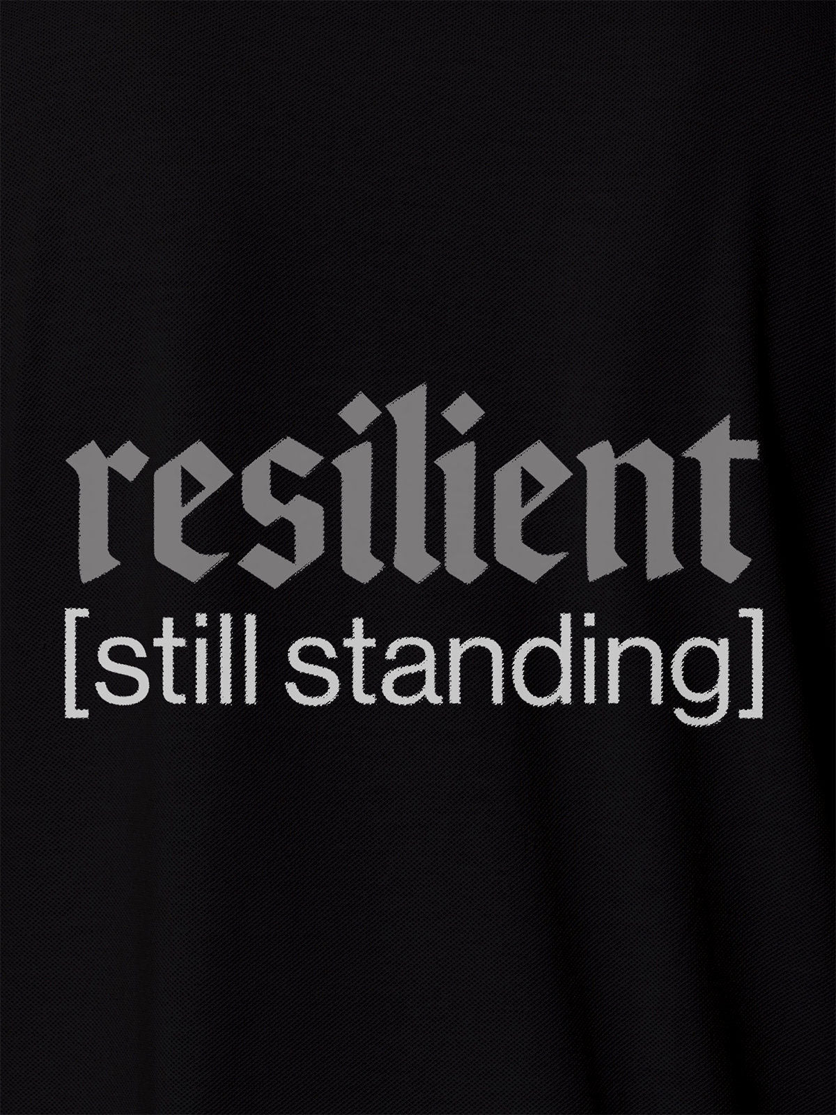 Close up of 'Resilient' design on Men's Black Polo T-shirt, highlighting intricate details and vibrant print.