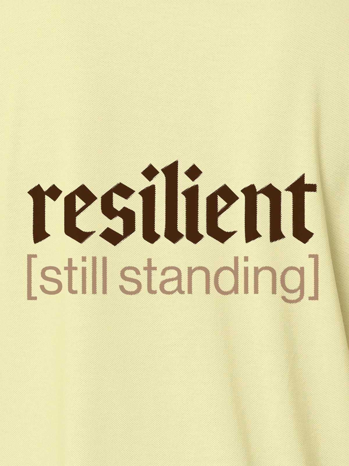 Close up of 'Resilient' design on Men's Yellow Polo T-shirt, highlighting intricate details and vibrant print.