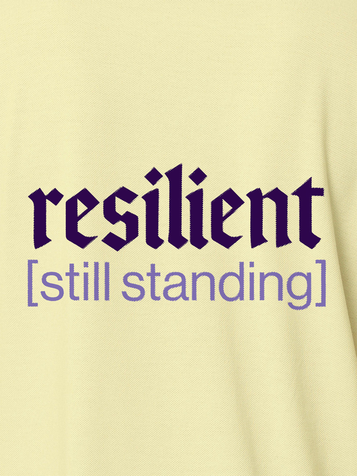 Close up of 'Resilient' design on Men's Yellow Polo T-shirt, highlighting intricate details and vibrant print.