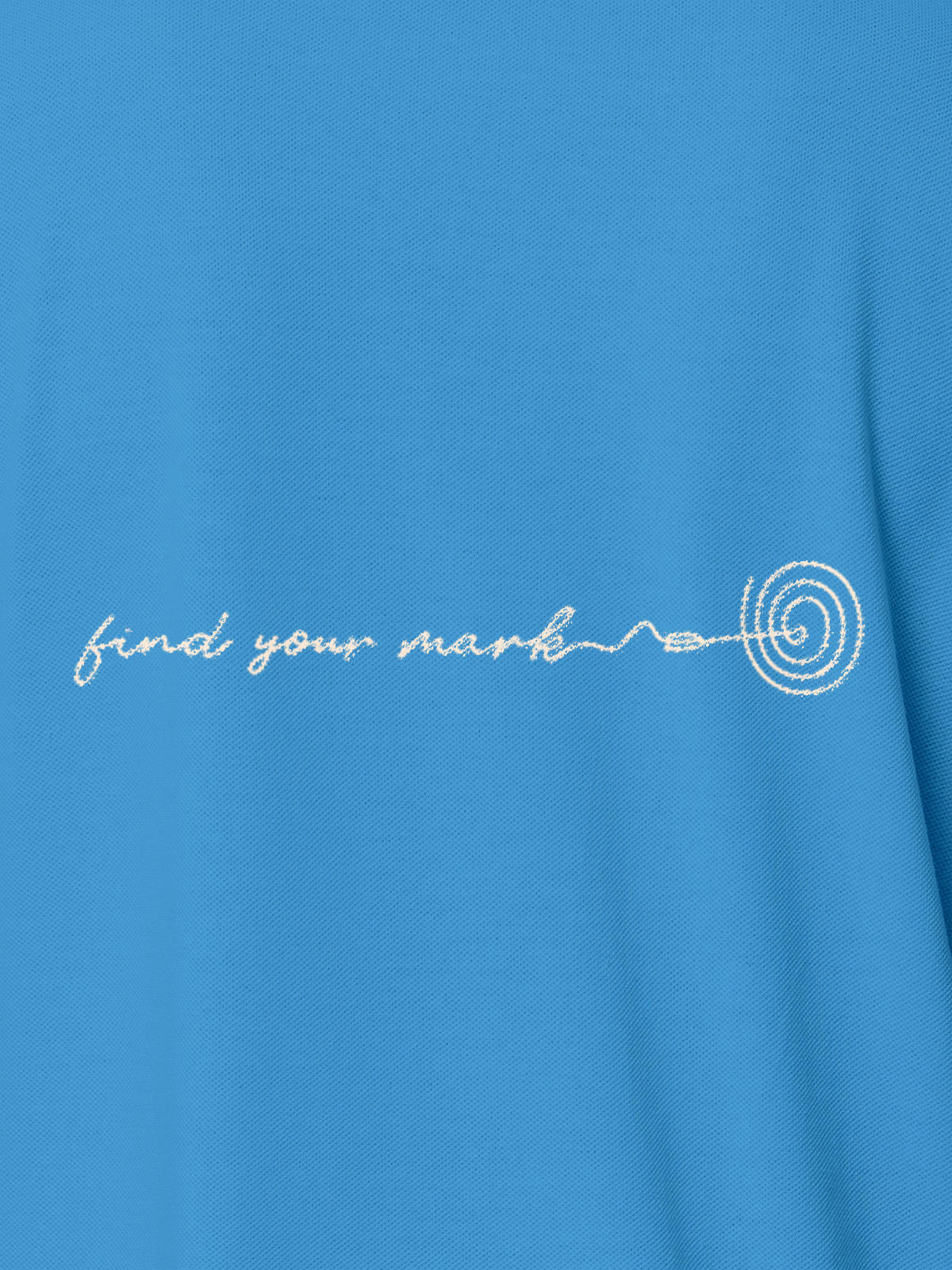 Close up of 'Find Your Mark' design on Women's Blue Polo T-shirt, highlighting intricate details and vibrant print.