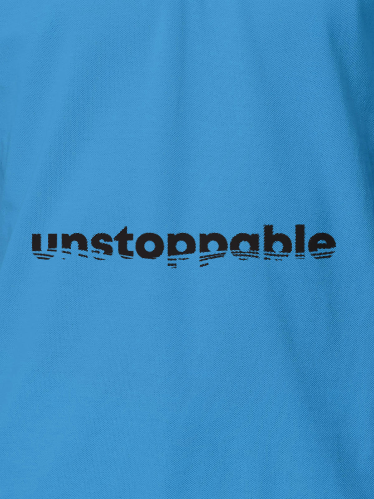 Close up of 'Unstoppable' design on Women's Blue Polo T-shirt, highlighting intricate details and vibrant print.