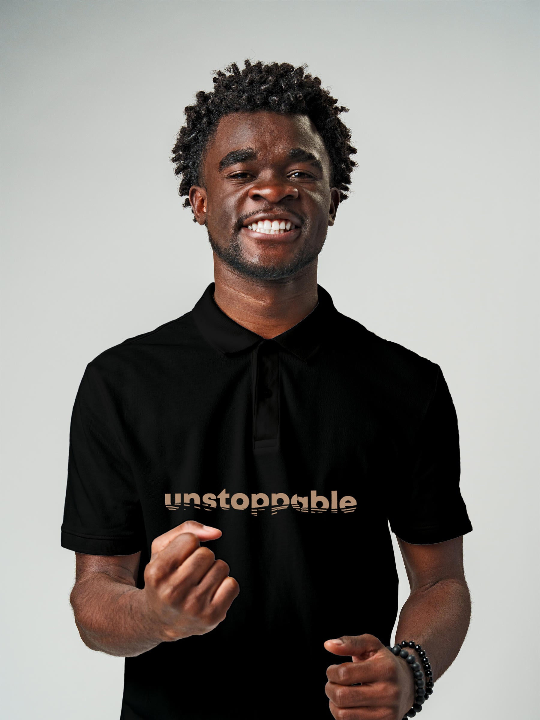 Model wearing Men's Black Polo T-shirt with 'Unstoppable' design, offering effortless style and premium comfort