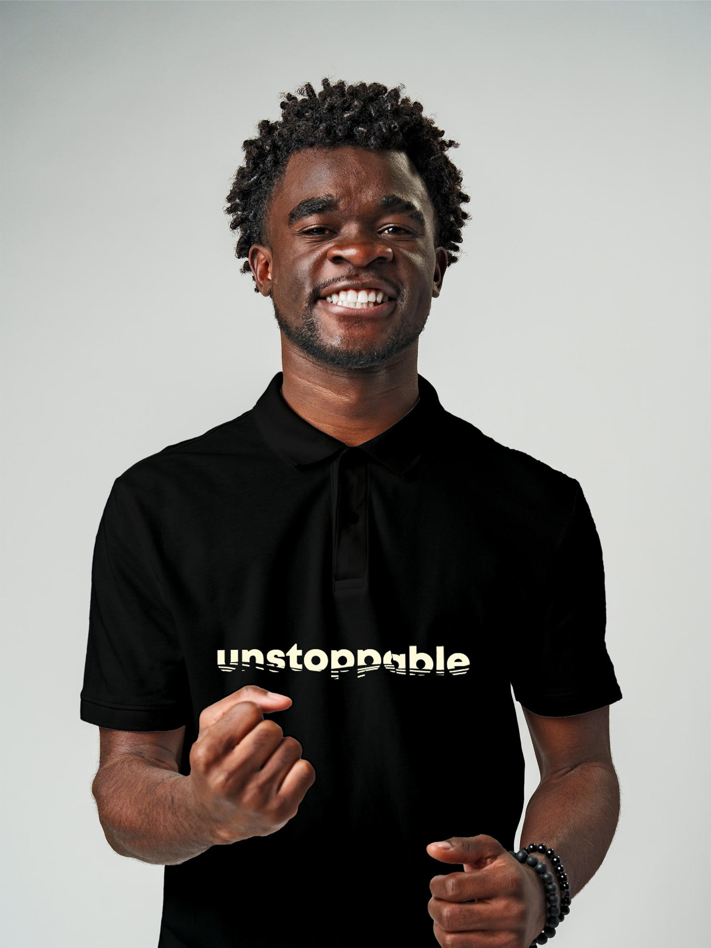 Model wearing Men's Black Polo T-shirt with 'Unstoppable' design, offering effortless style and premium comfort
