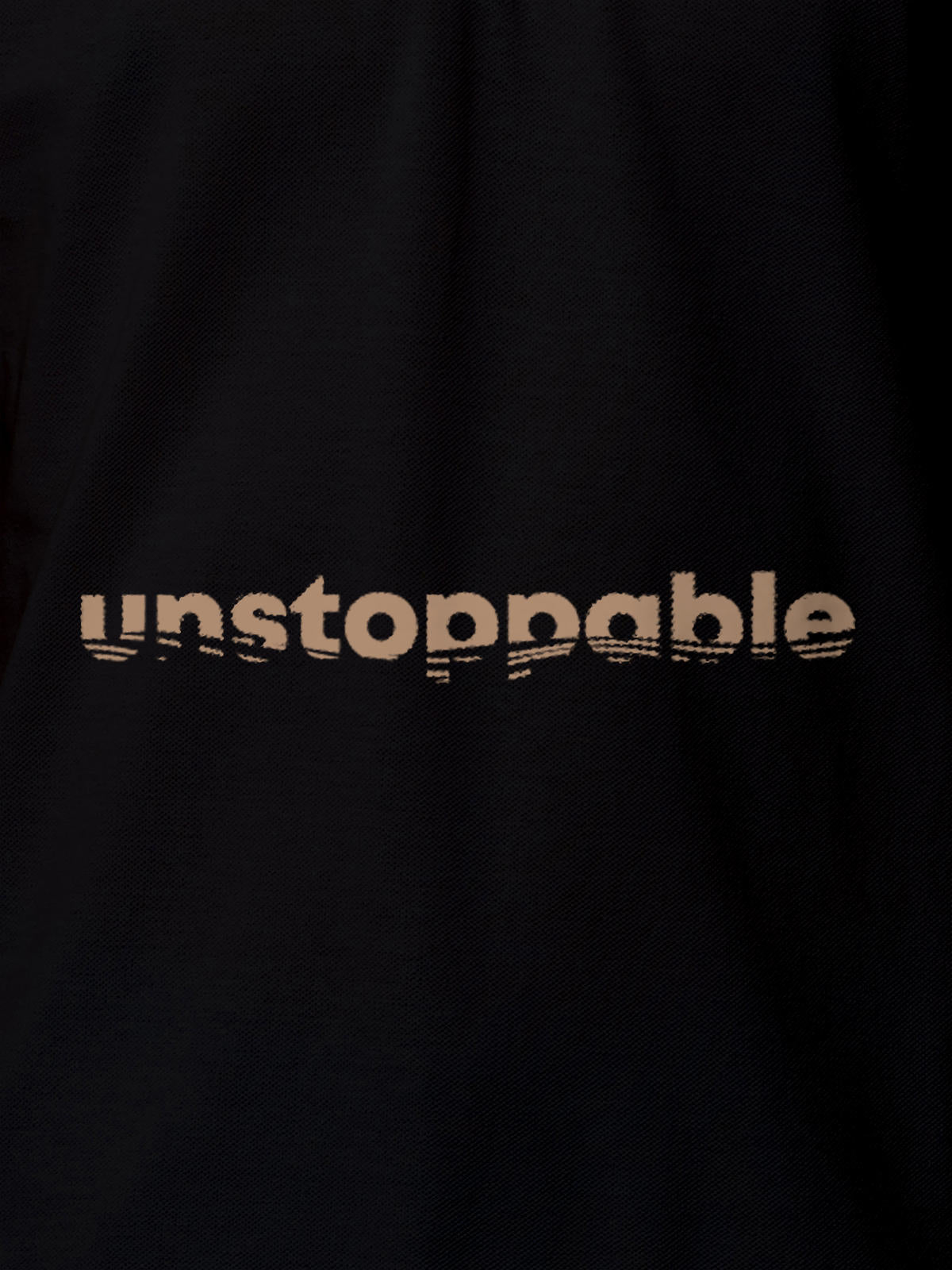Close up of 'Unstoppable' design on Women's Black Polo T-shirt, highlighting intricate details and vibrant print.