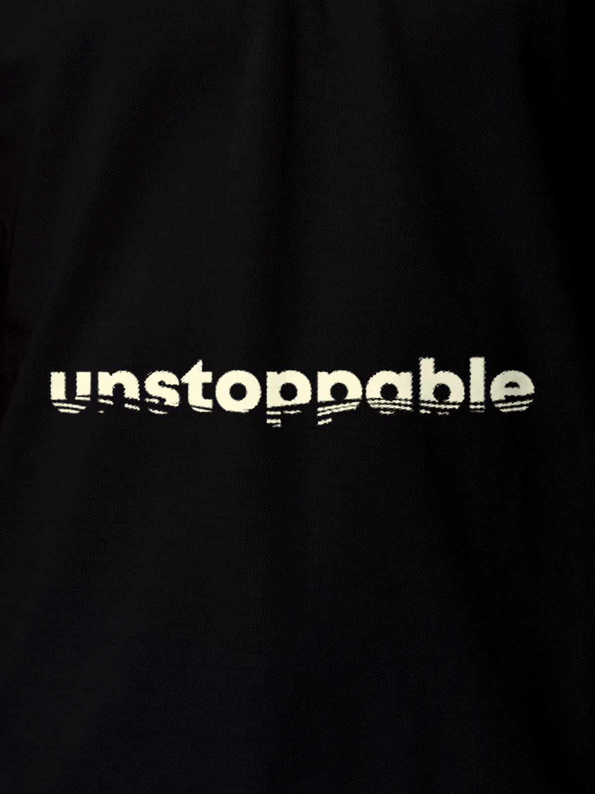 Close up of 'Unstoppable' design on Women's Black Polo T-shirt, highlighting intricate details and vibrant print.