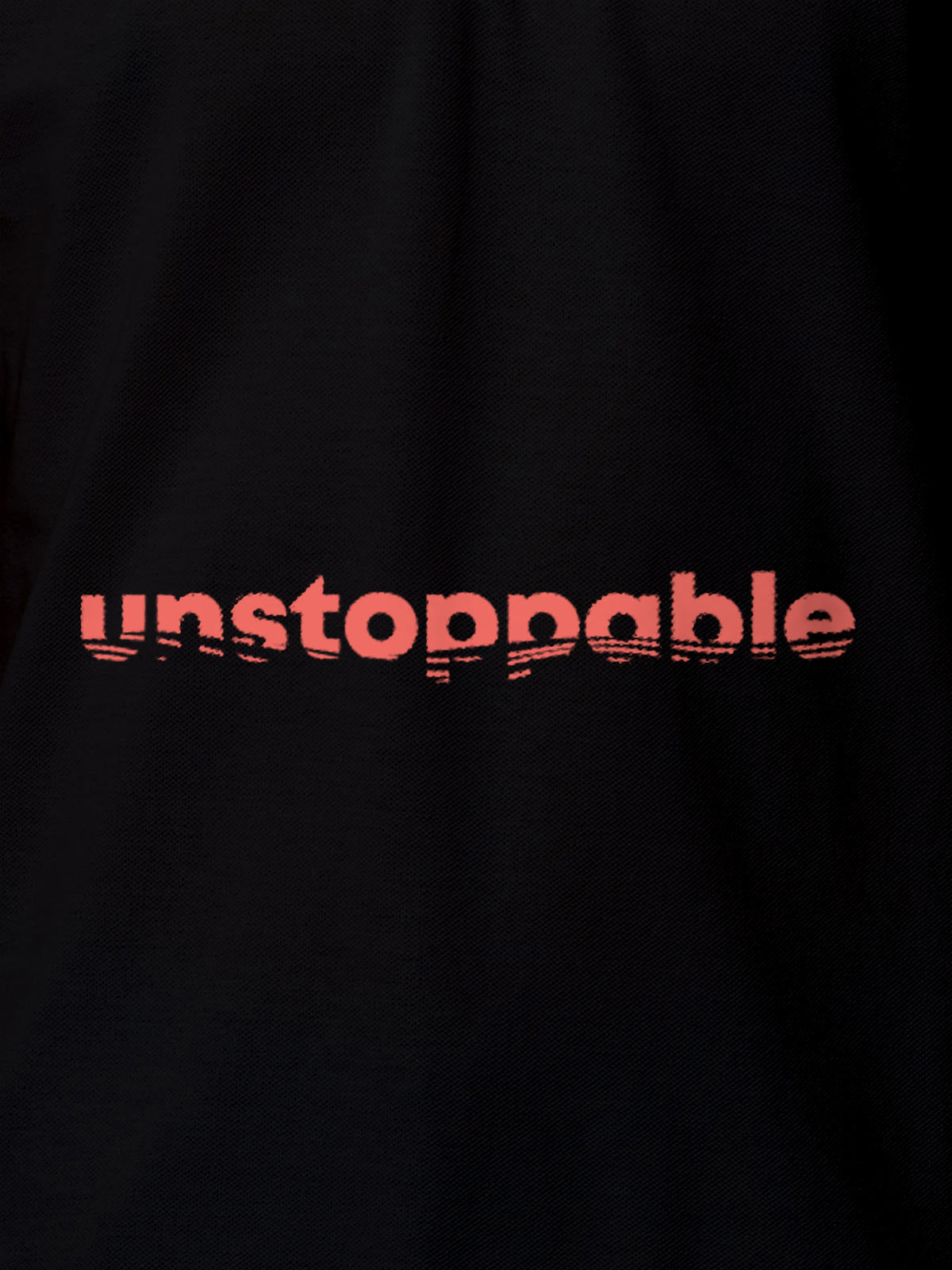 Close up of 'Unstoppable' design on Women's Black Polo T-shirt, highlighting intricate details and vibrant print.