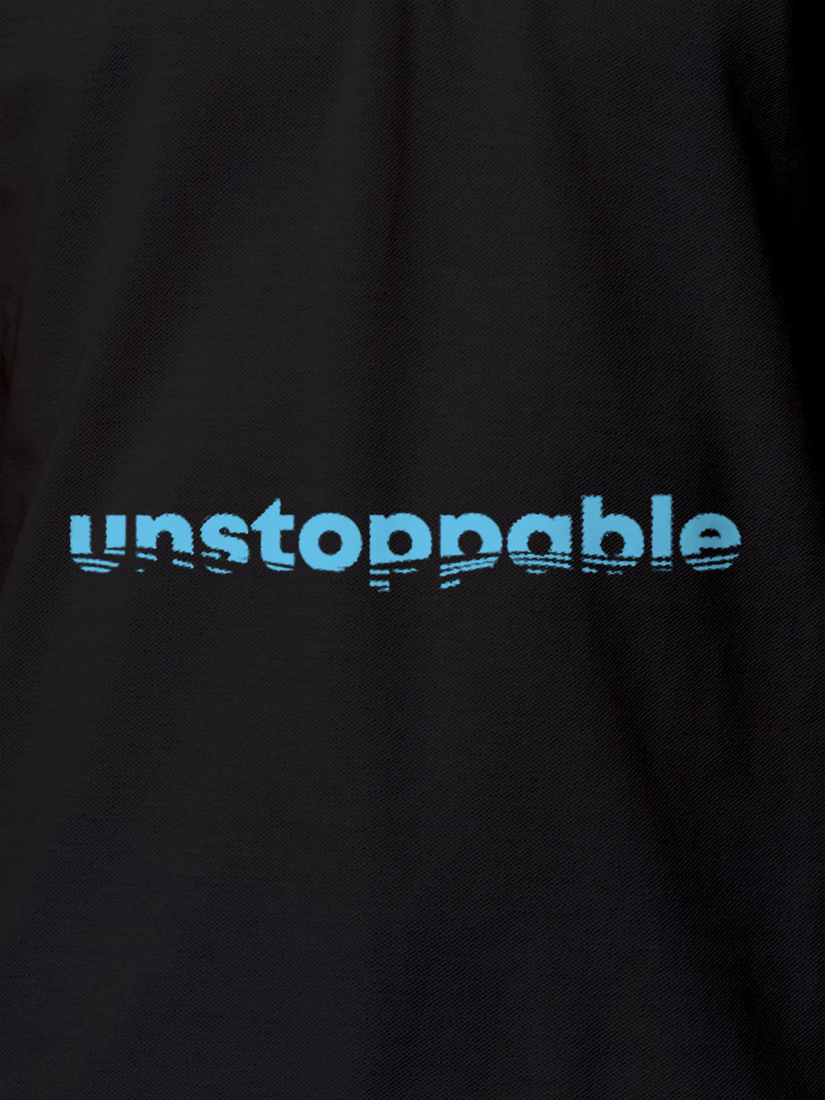 Close up of 'Unstoppable' design on Women's Dark Grey Polo T-shirt, highlighting intricate details and vibrant print.