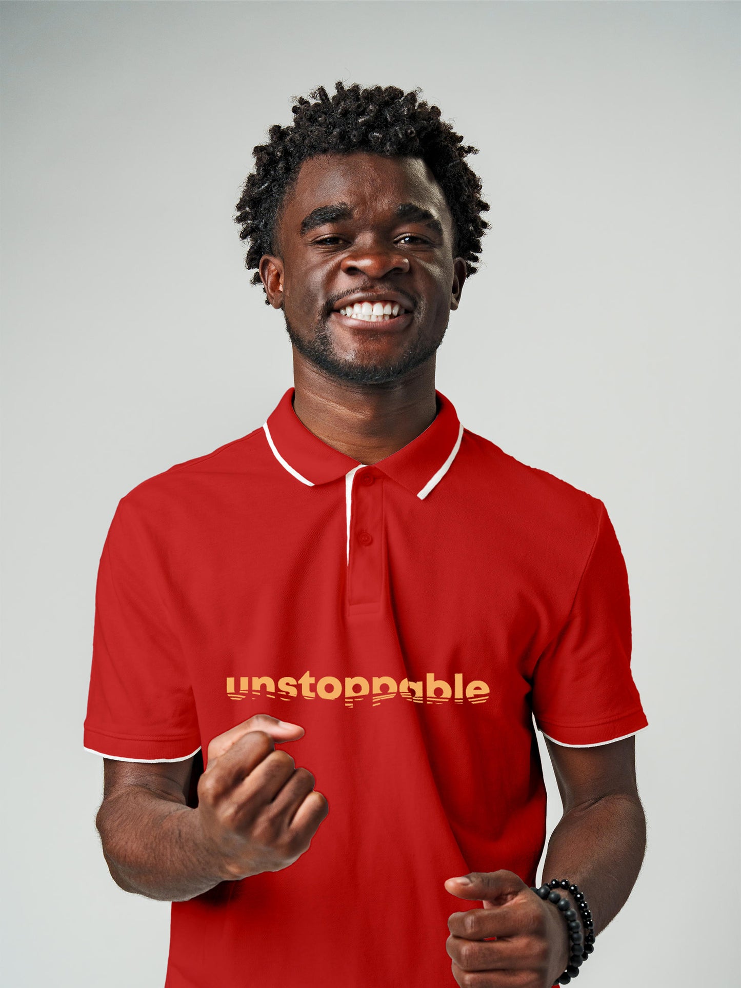 Model wearing Men's Red Polo T-shirt with 'Unstoppable' design, offering effortless style and premium comfort