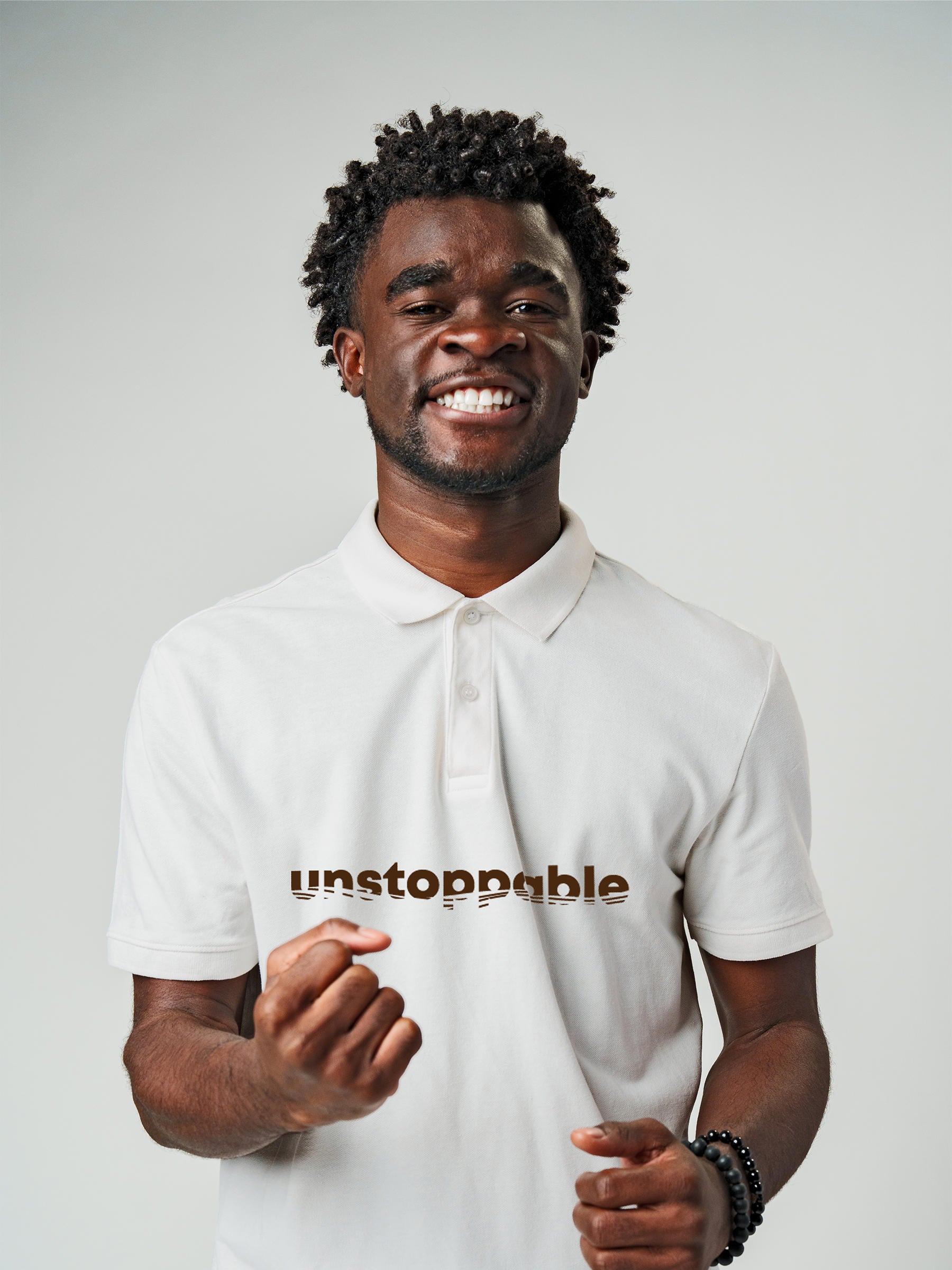 Model wearing Men's White Polo T-shirt with 'Unstoppable' design, offering effortless style and premium comfort