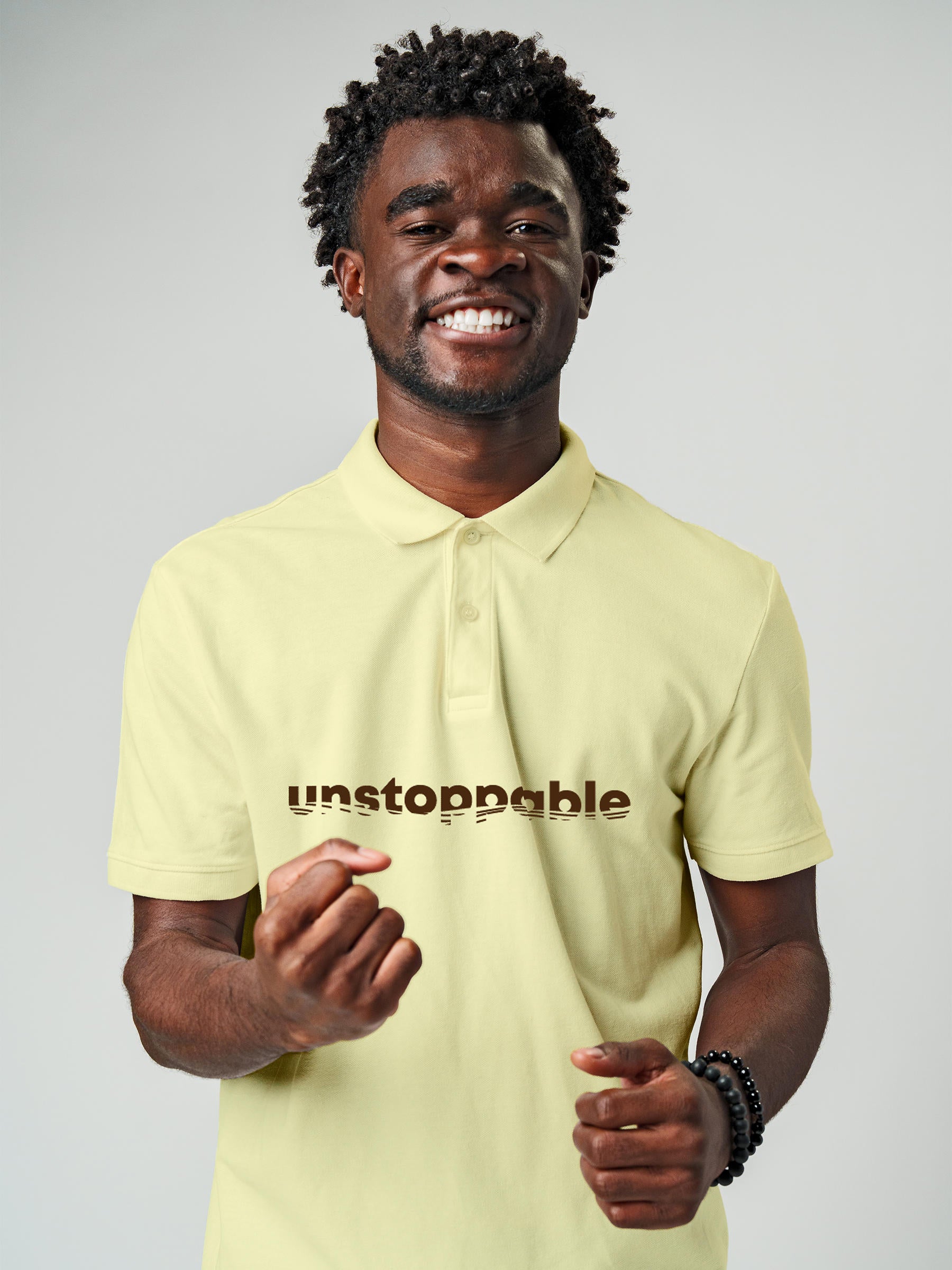 Model wearing Men's Yellow Polo T-shirt with 'Unstoppable' design, offering effortless style and premium comfort