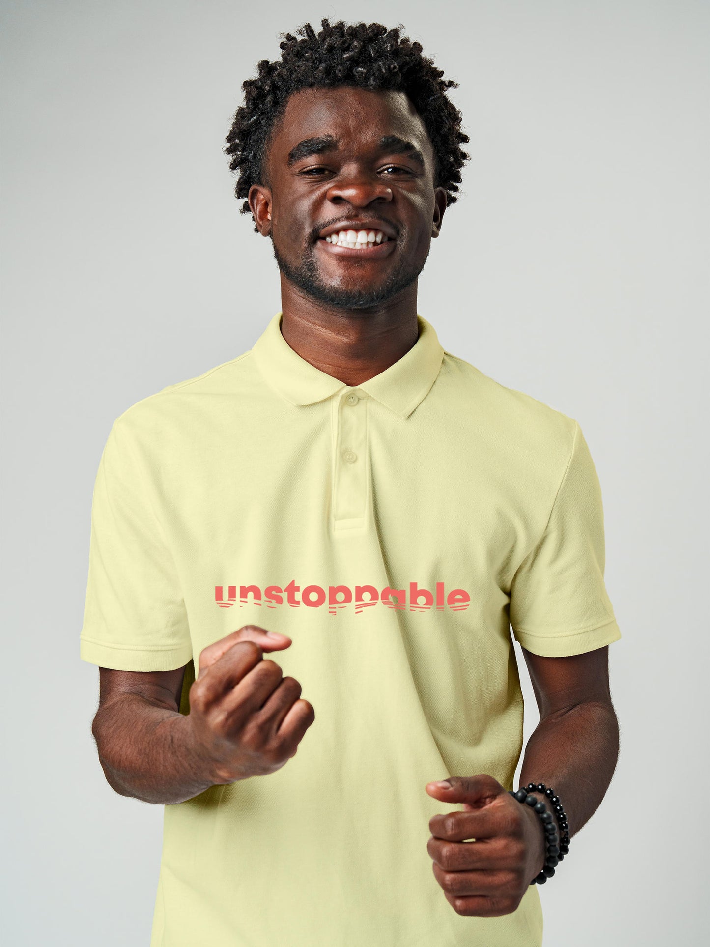 Model wearing Men's Yellow Polo T-shirt with 'Unstoppable' design, offering effortless style and premium comfort