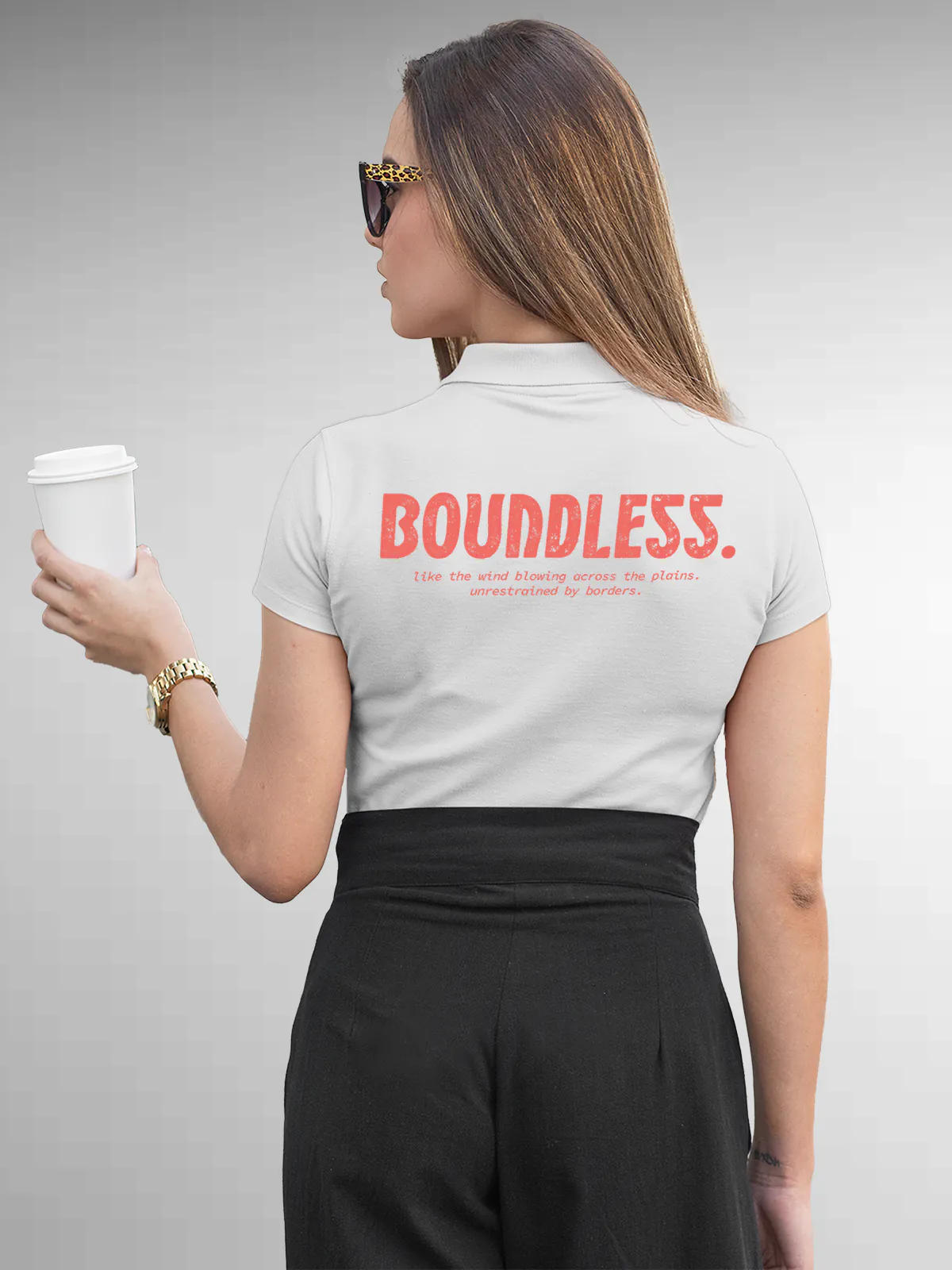 Model wearing Women's White Collar T-shirt with a big, bold 'Boundless' design printed on the back, along with an insiprational text