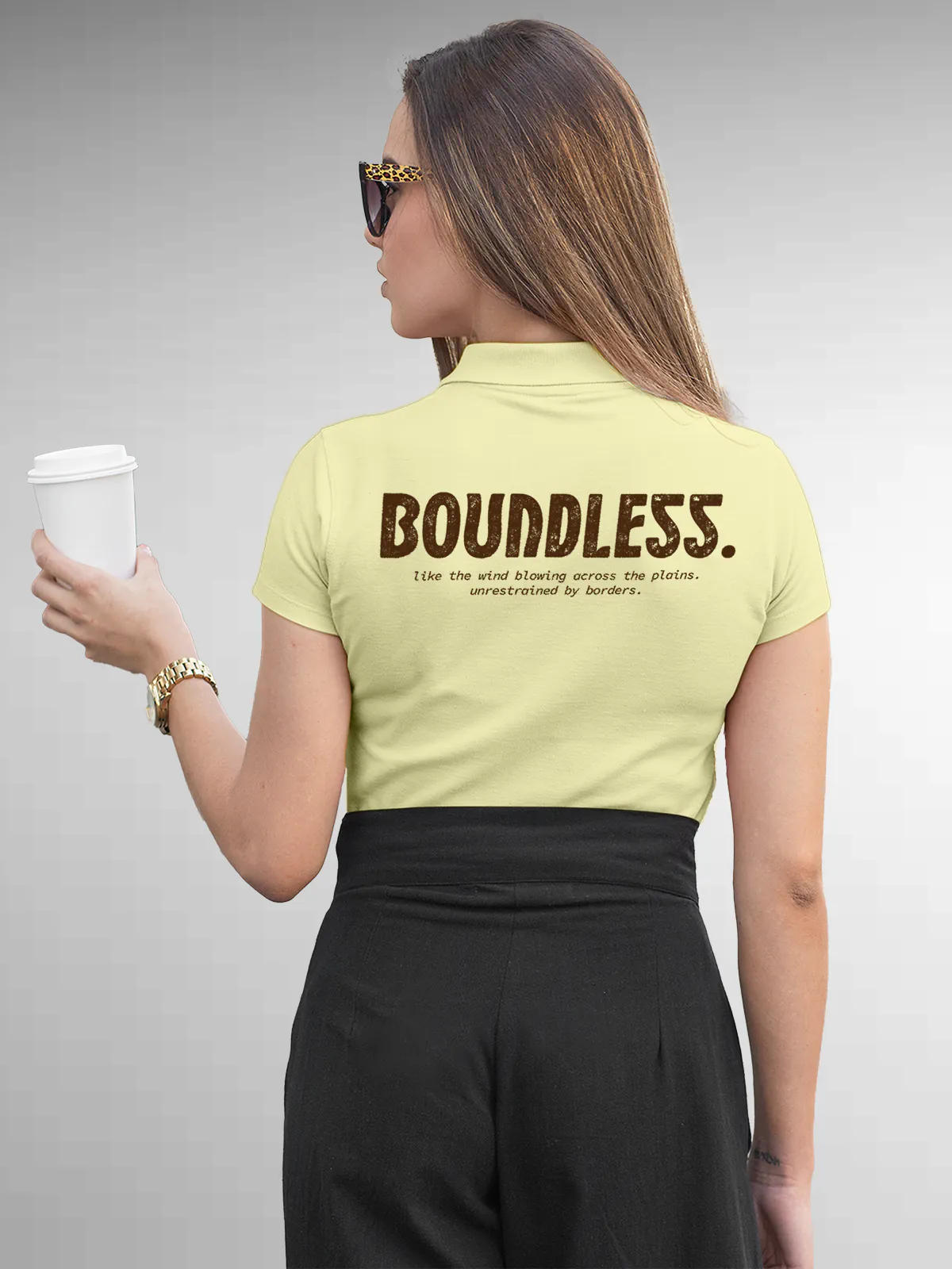 Model wearing Women's Yellow Collar T-shirt with a big, bold 'Boundless' design printed on the back, along with an insiprational text