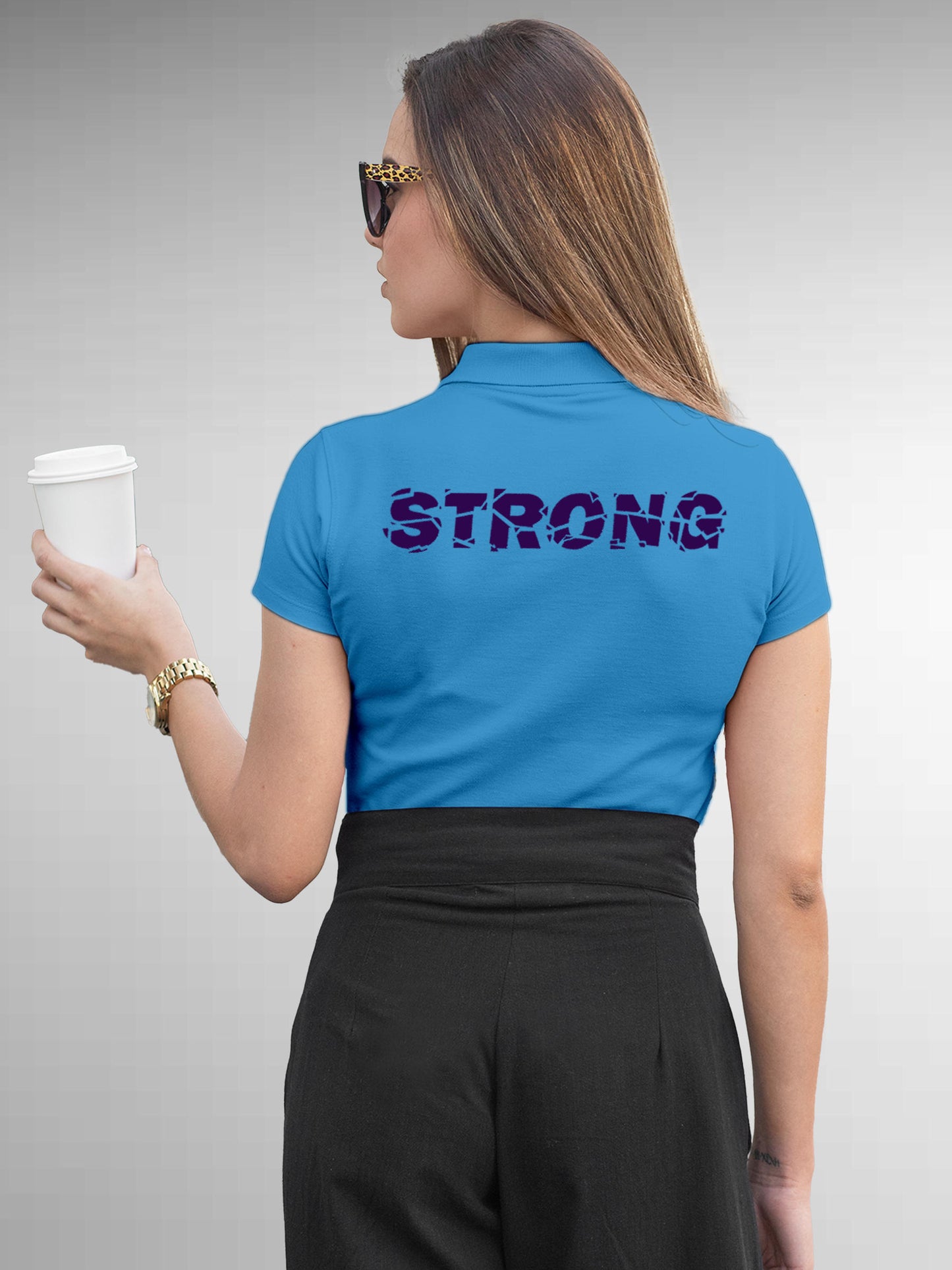 Model wearing Women's Blue Polo T-shirt with 'Strong' design, offering effortless style and premium comfort