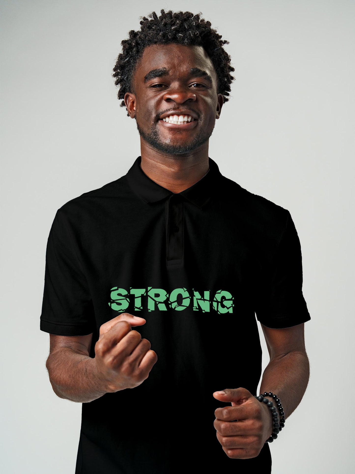 Model wearing Men's Black Polo T-shirt with 'Strong' design, offering effortless style and premium comfort