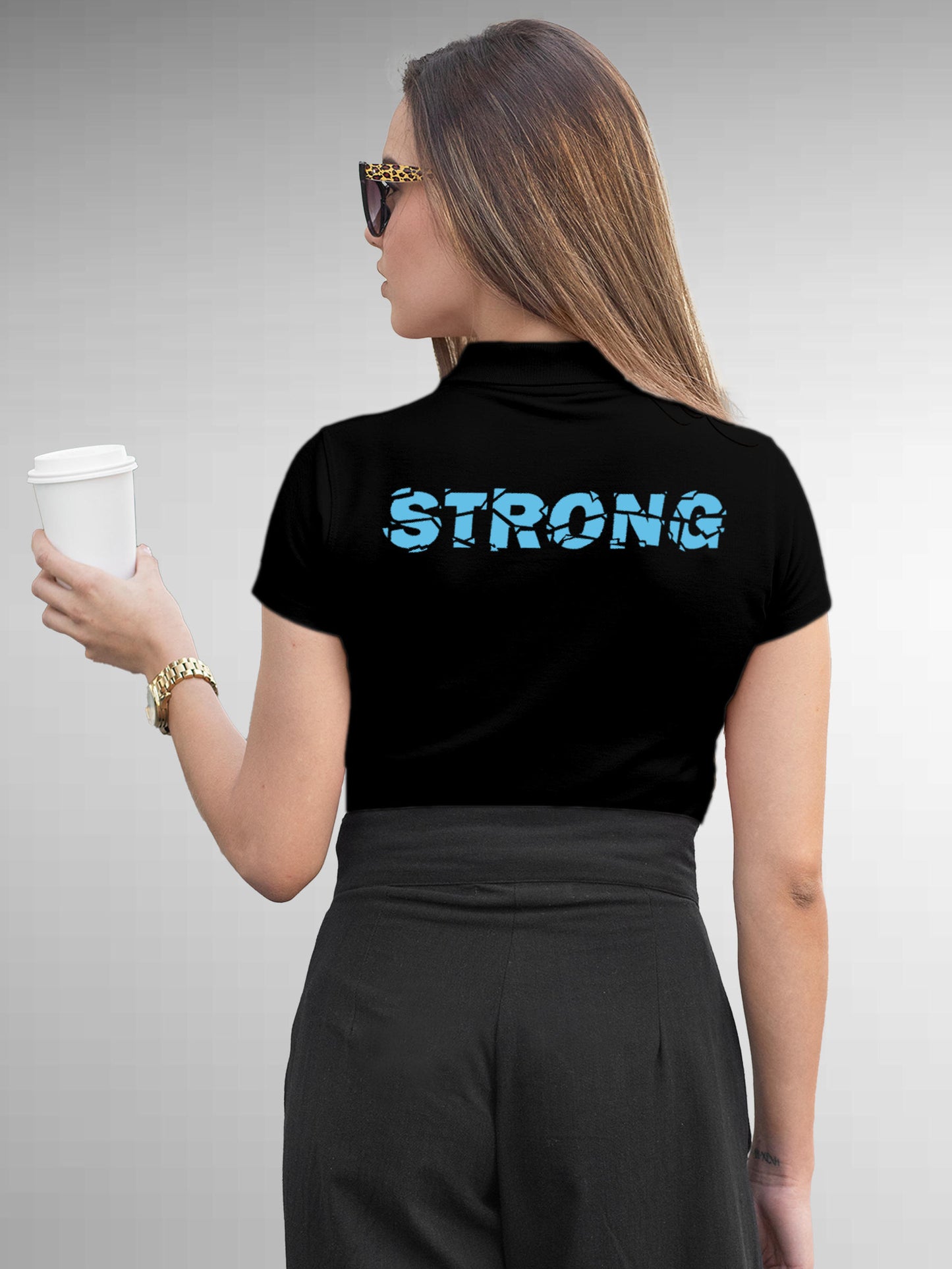 Model wearing Women's Black Polo T-shirt with 'Strong' design, offering effortless style and premium comfort