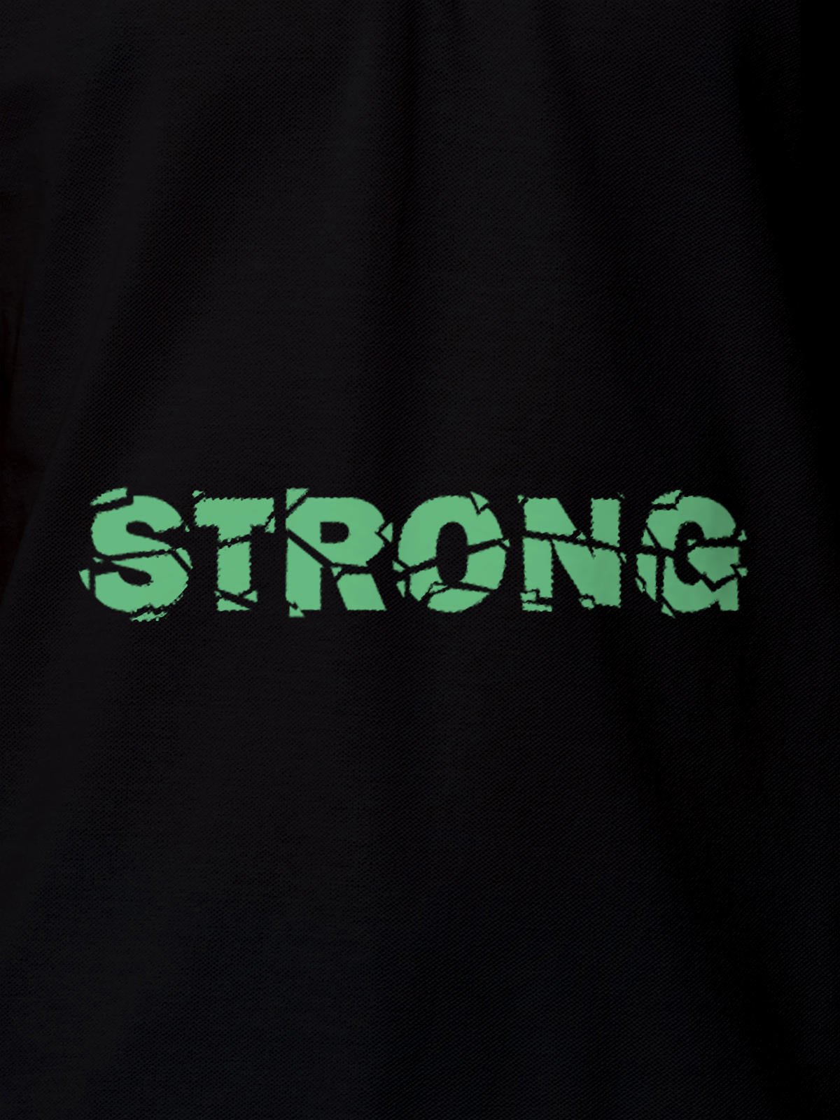 Close up of 'Strong' design on Women's Black Polo T-shirt, highlighting intricate details and vibrant print.