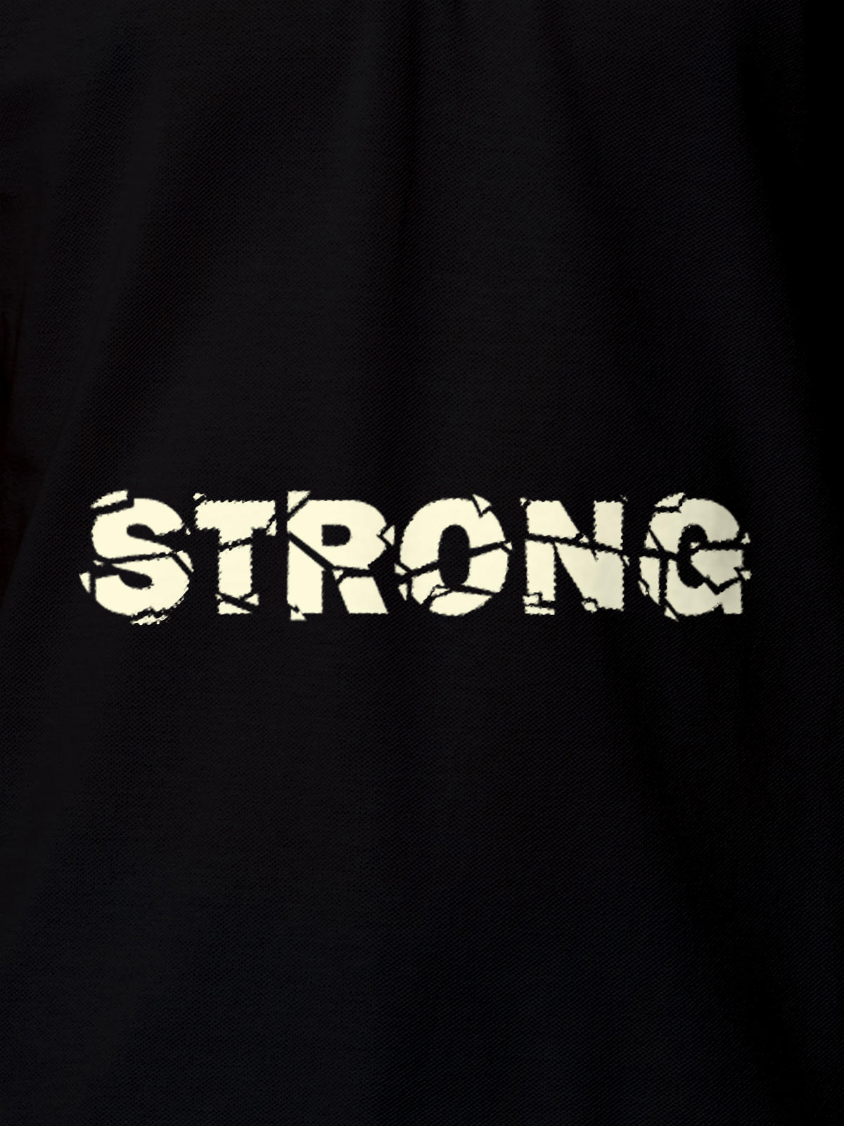 Close up of 'Strong' design on Women's Black Polo T-shirt, highlighting intricate details and vibrant print.