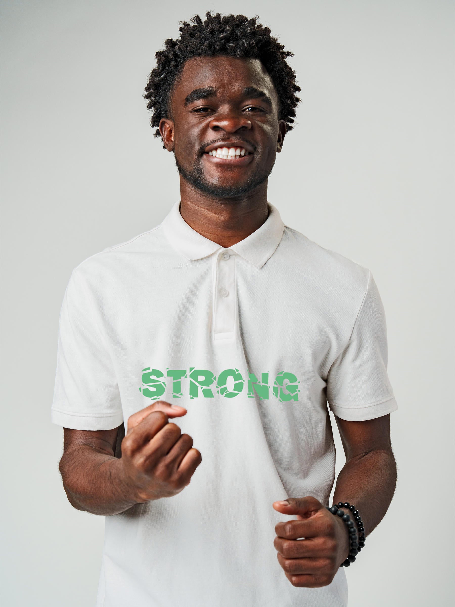 Model wearing Men's White Polo T-shirt with 'Strong' design, offering effortless style and premium comfort