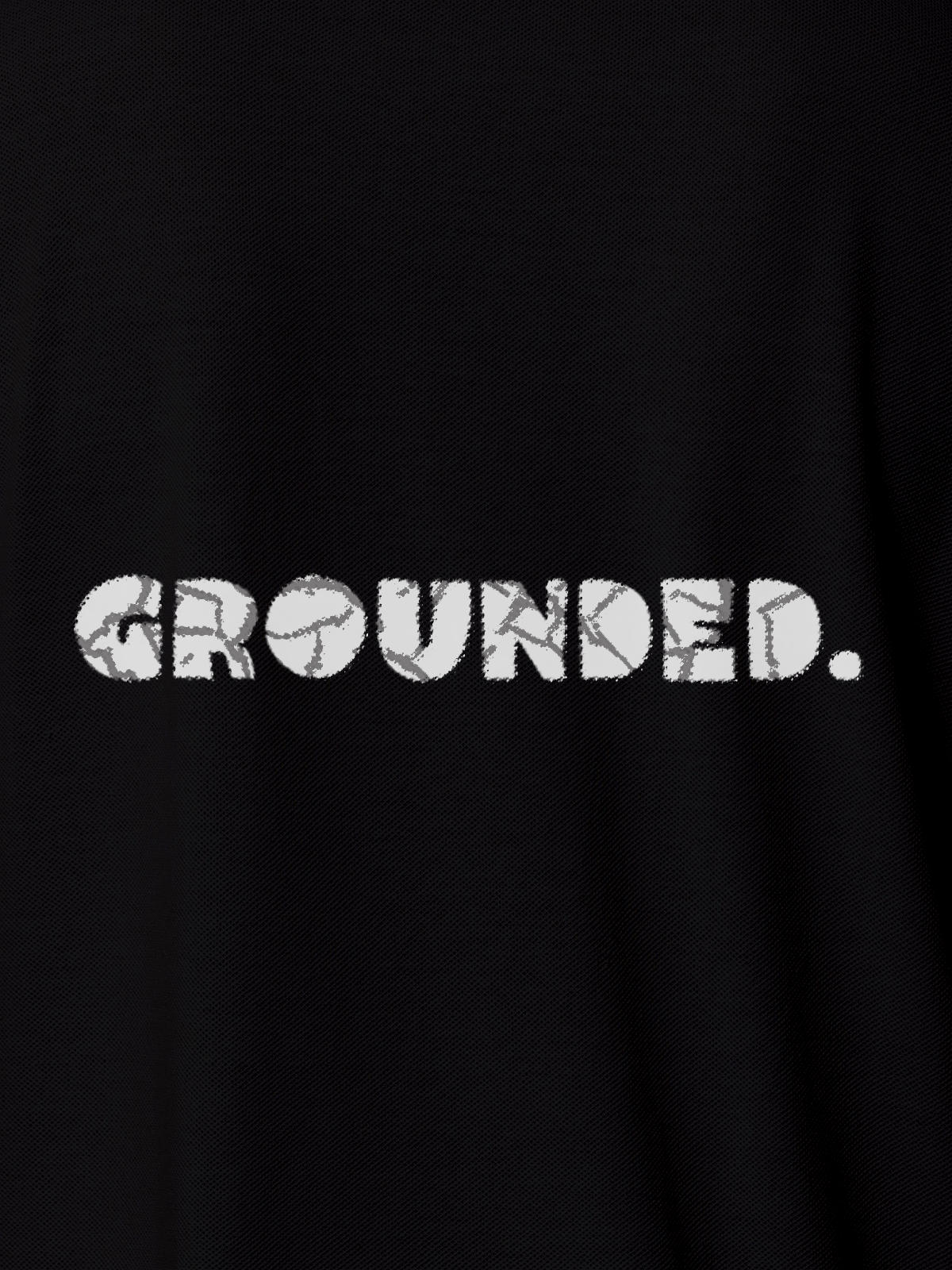 Close up of 'Grounded' design on Women's Black Polo T-shirt, highlighting intricate details and vibrant print.