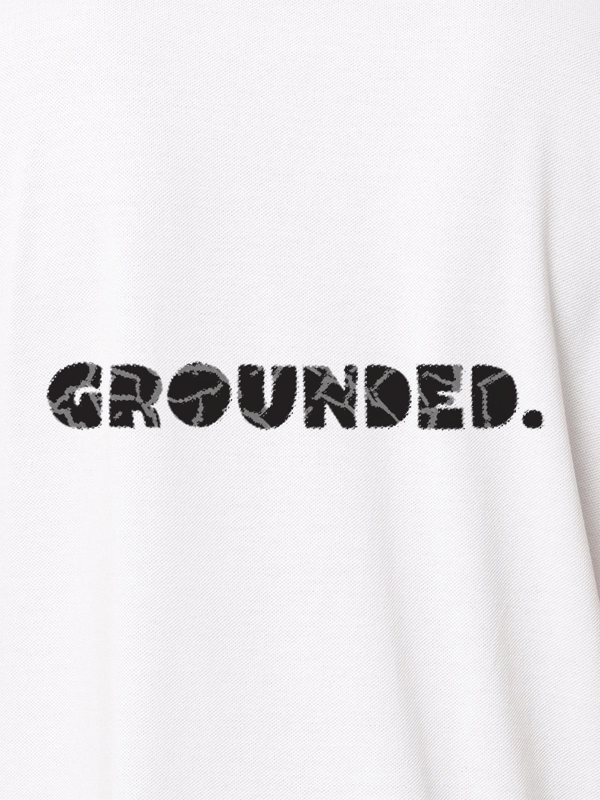 Close up of 'Grounded' design on Women's White Polo T-shirt, highlighting intricate details and vibrant print.
