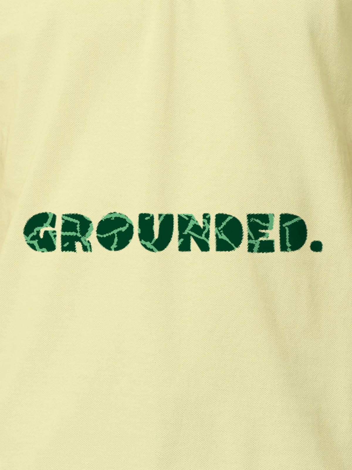 Close up of 'Grounded' design on Men's Yellow Polo T-shirt, highlighting intricate details and vibrant print.