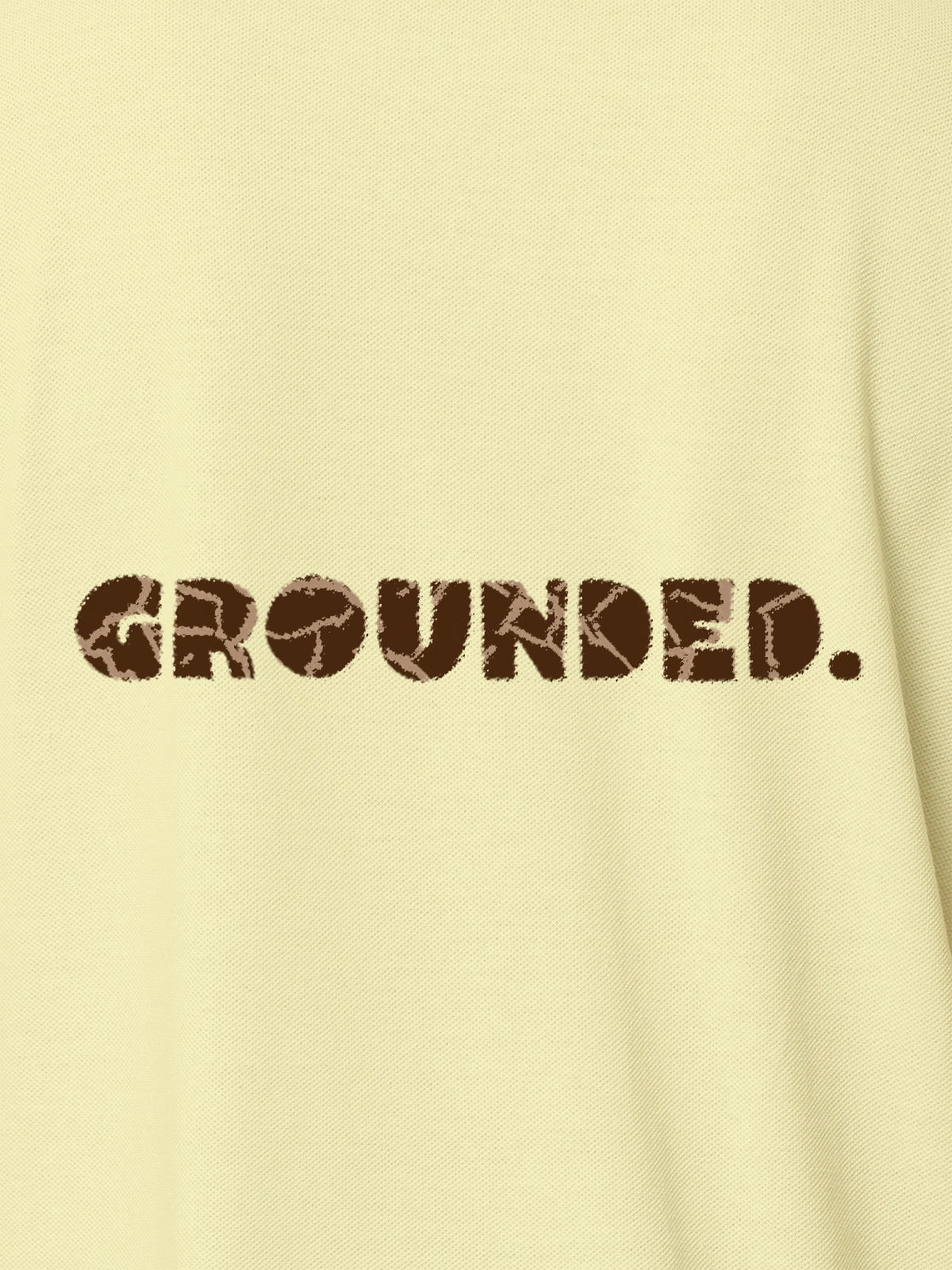 Close up of 'Grounded' design on Women's Yellow Polo T-shirt, highlighting intricate details and vibrant print.
