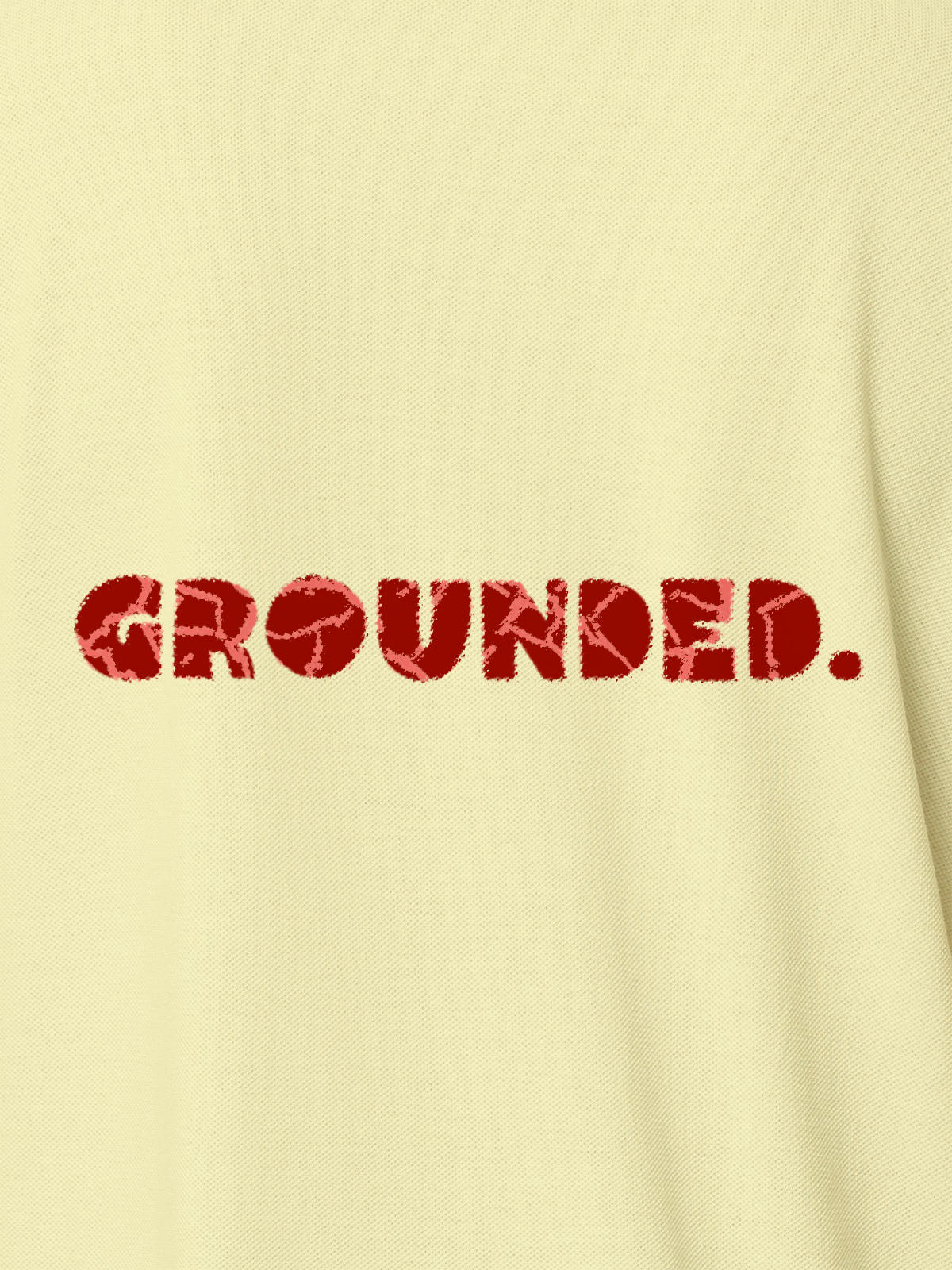 Close up of 'Grounded' design on Women's Yellow Polo T-shirt, highlighting intricate details and vibrant print.