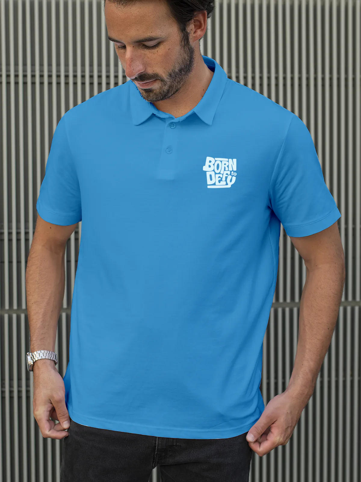 Model wearing Men's Blue Polo T-shirt with 'Born To Defy' design, offering effortless style and premium comfort