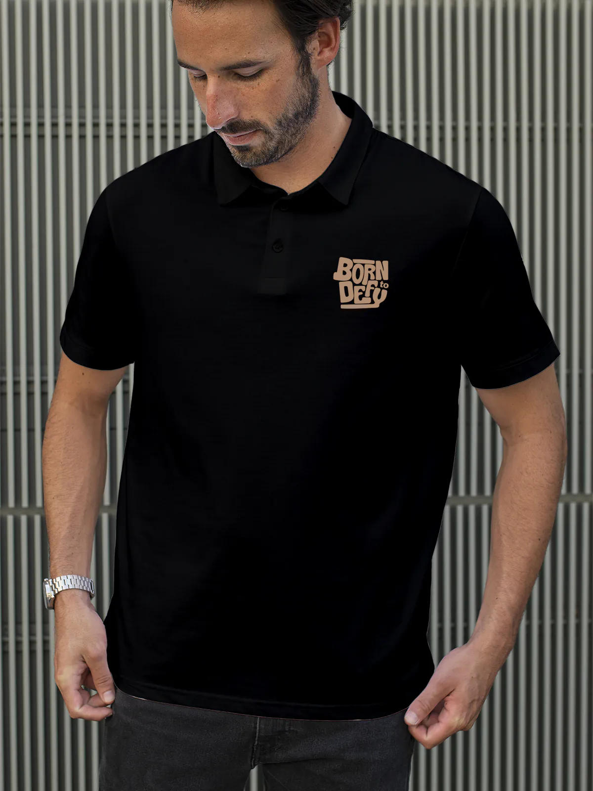Model wearing Men's Black Polo T-shirt with 'Born To Defy' design, offering effortless style and premium comfort