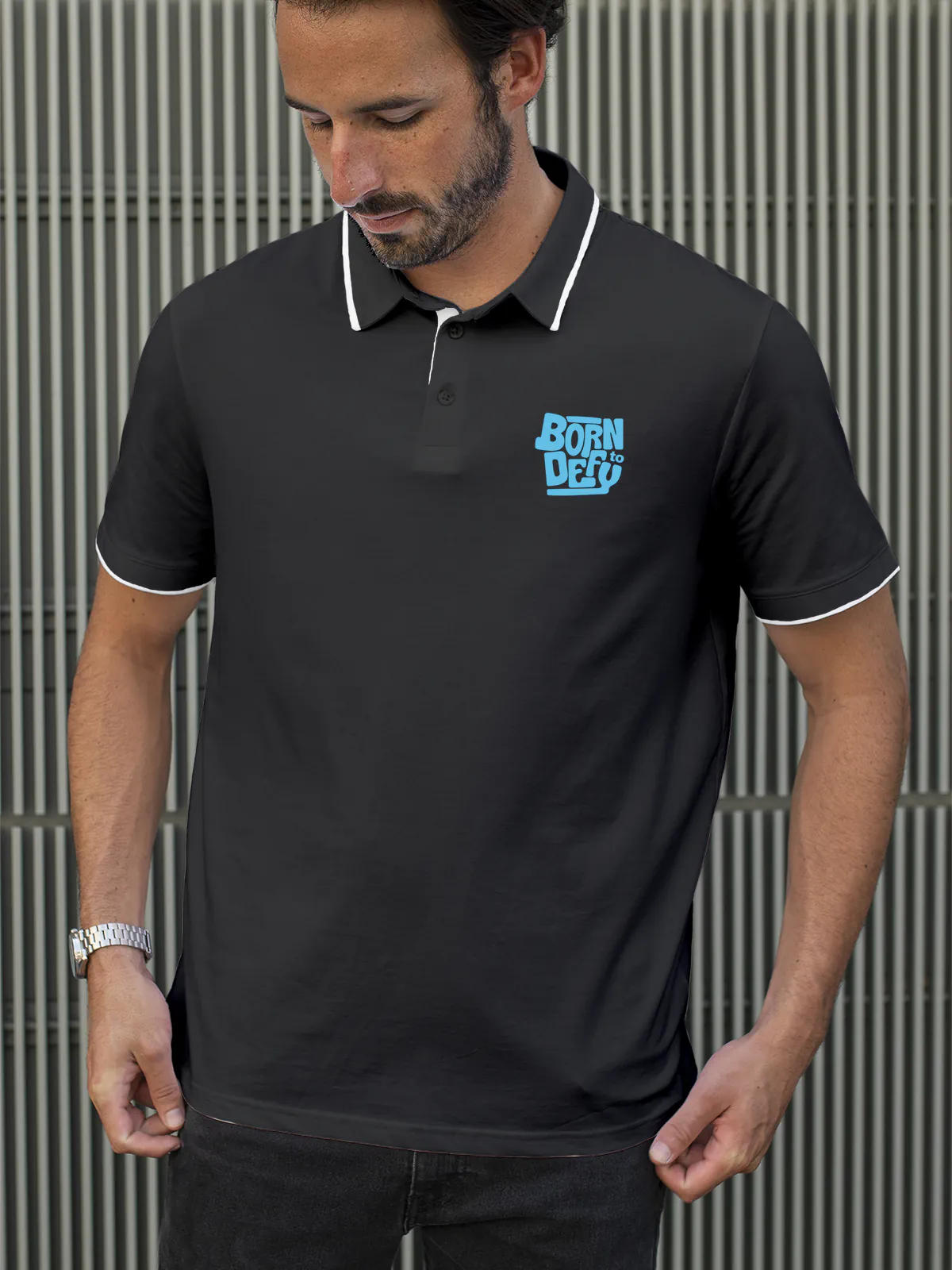Model wearing Men's Dark Grey Polo T-shirt with 'Born To Defy' design, offering effortless style and premium comfort