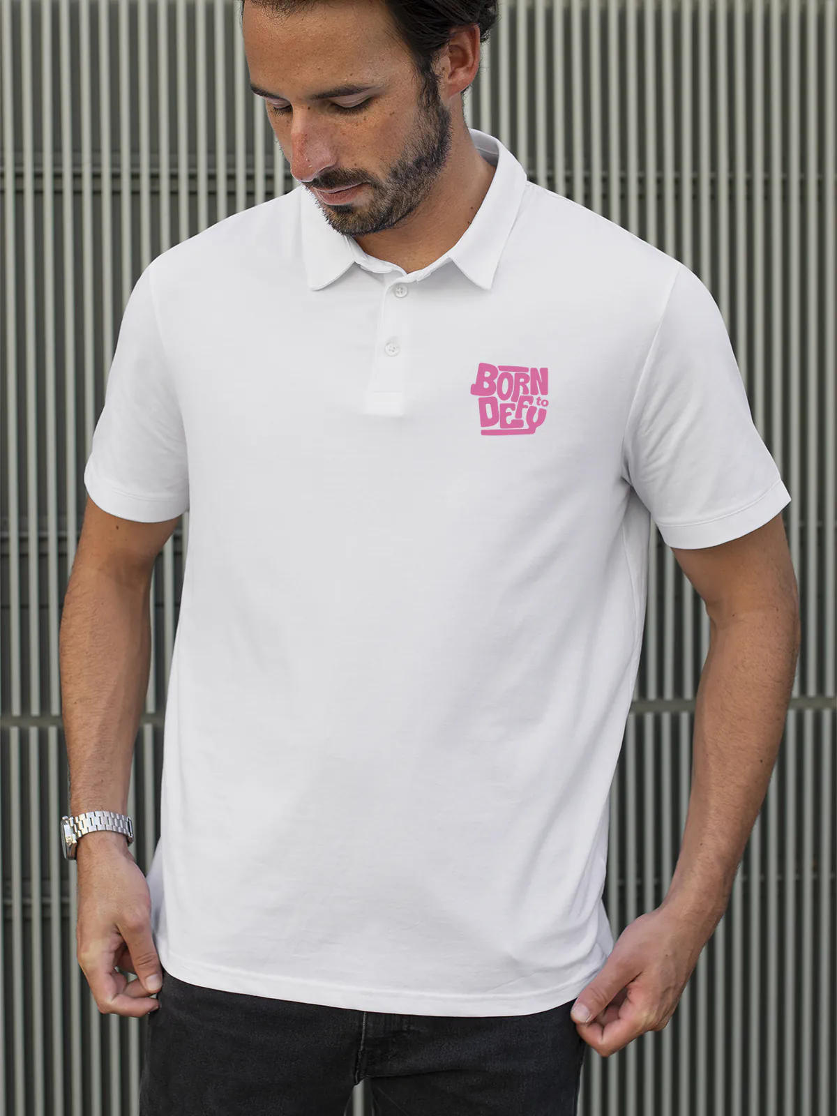 Model wearing Men's White Polo T-shirt with 'Born To Defy' design, offering effortless style and premium comfort