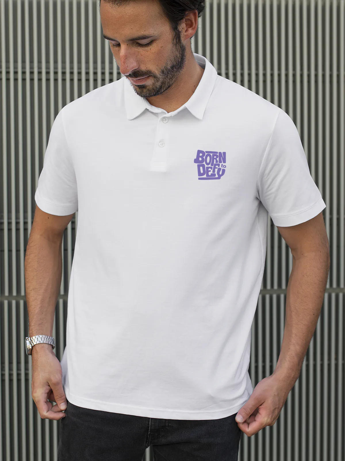 Model wearing Men's White Polo T-shirt with 'Born To Defy' design, offering effortless style and premium comfort