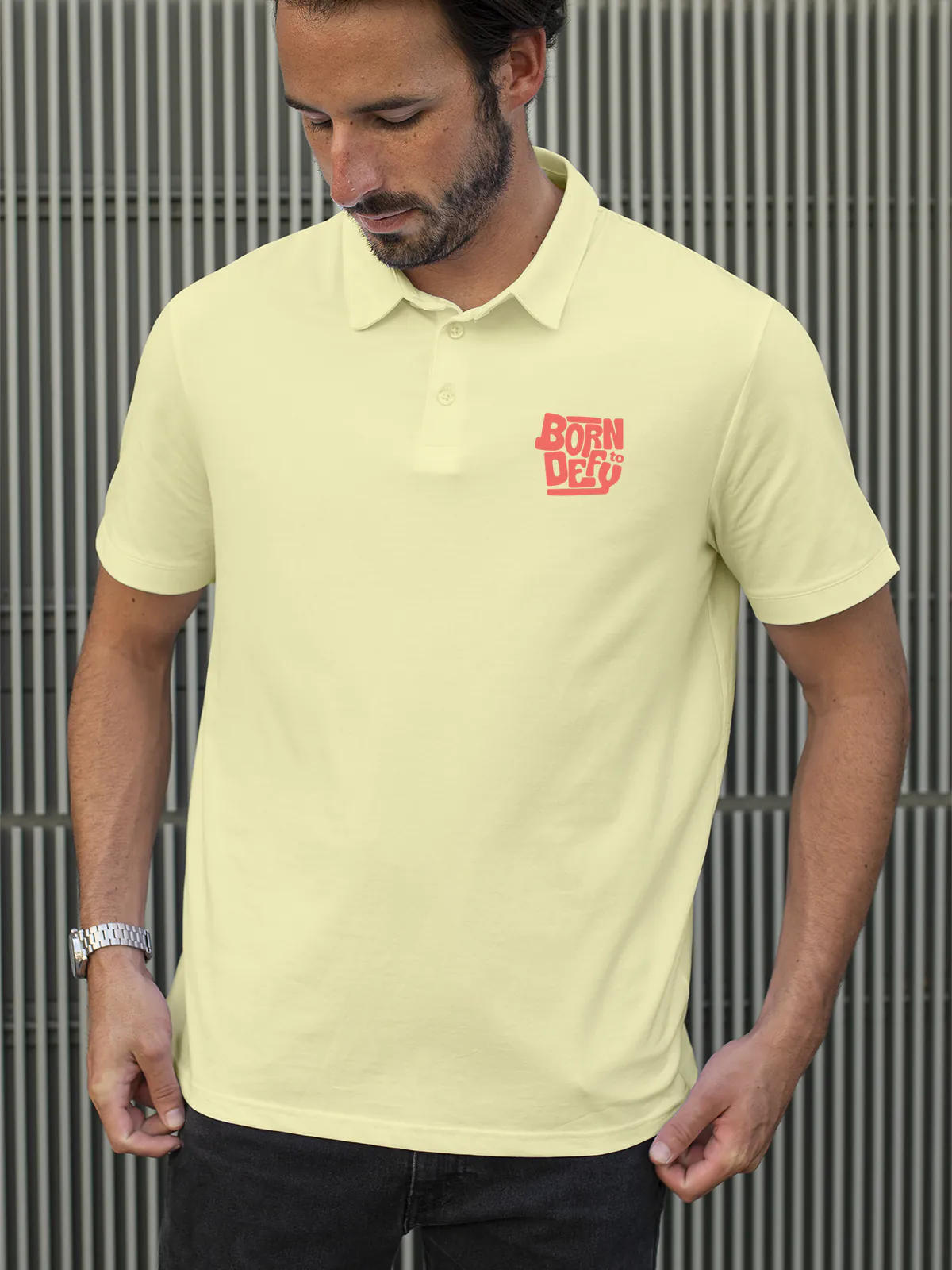 Model wearing Men's Yellow Polo T-shirt with 'Born To Defy' design, offering effortless style and premium comfort