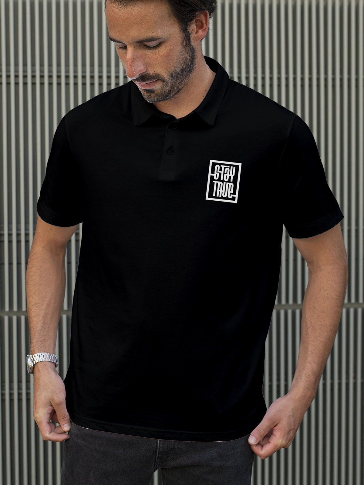 Model wearing Men's Black Polo T-shirt with 'Stay True' design, offering effortless style and premium comfort