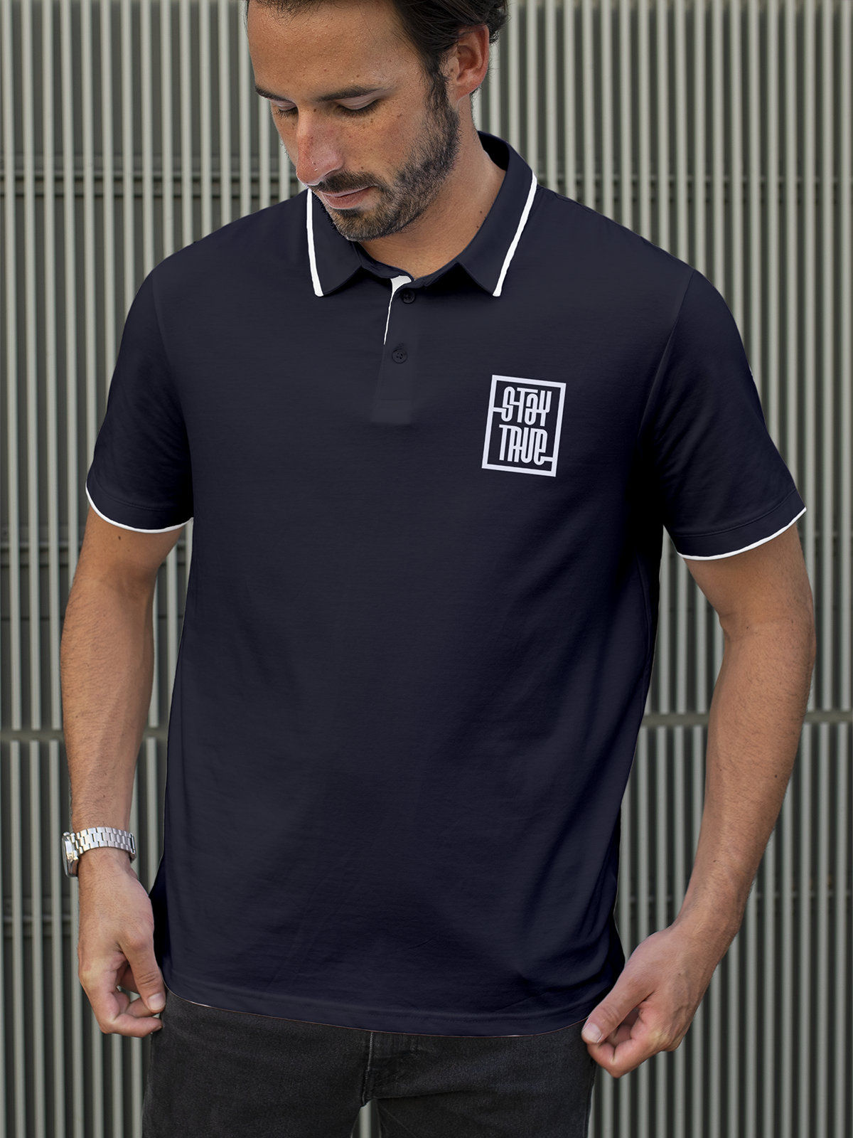 Model wearing Men's Navy Blue Polo T-shirt with 'Stay True' design, offering effortless style and premium comfort