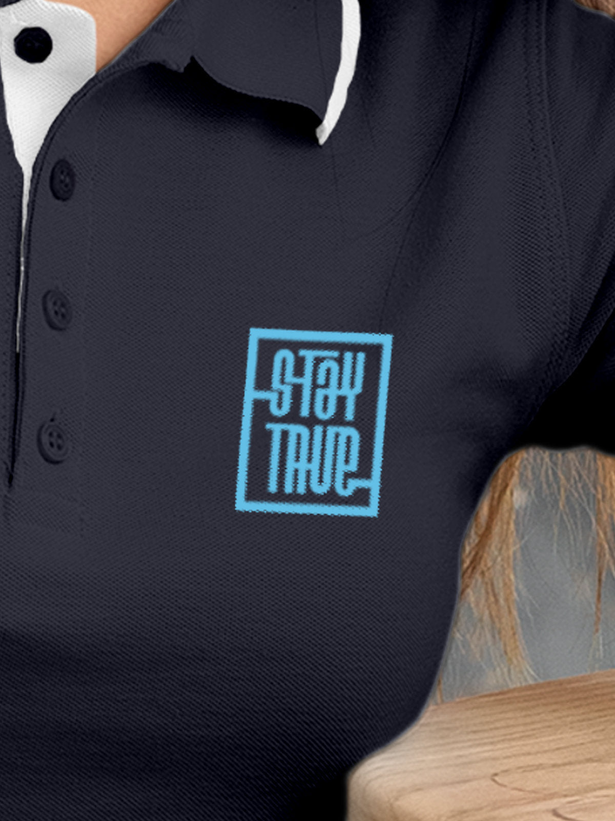 Close up of 'Stay True' on Women's Navy Blue Polo T-shirt, highlighting intricate details and vibrant print.