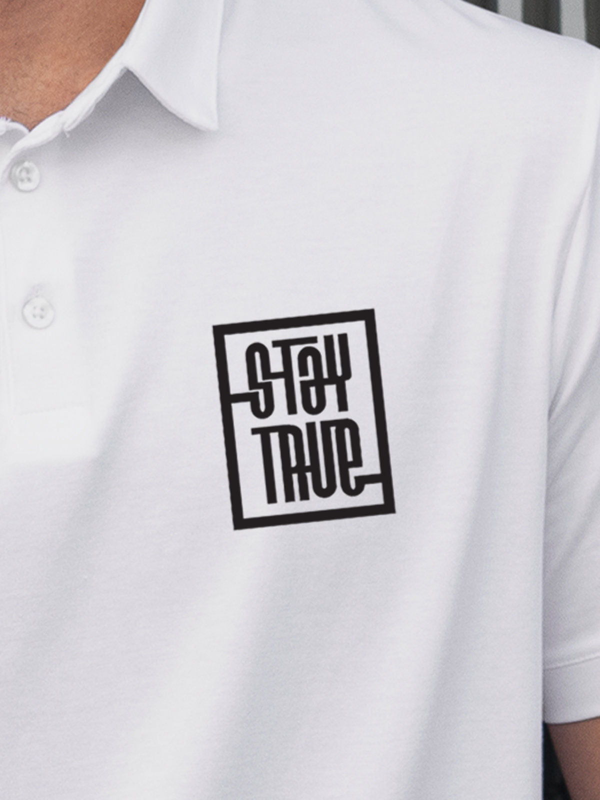 Close up of 'Stay True' design on Men's White Polo T-shirt, highlighting intricate details and vibrant print.