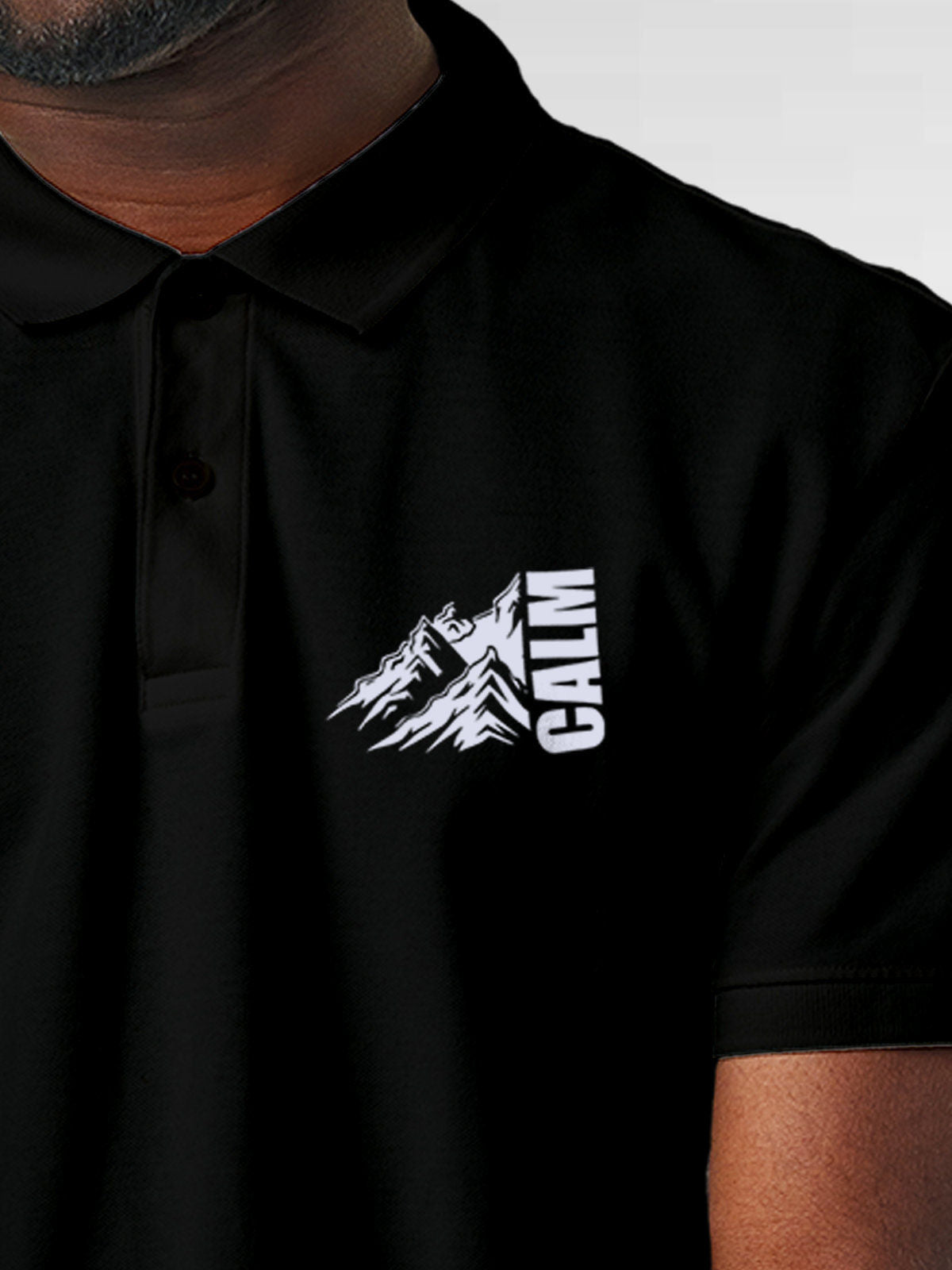 Close up of 'Calm' design on Men's Black Polo T-shirt, highlighting intricate details and vibrant print.