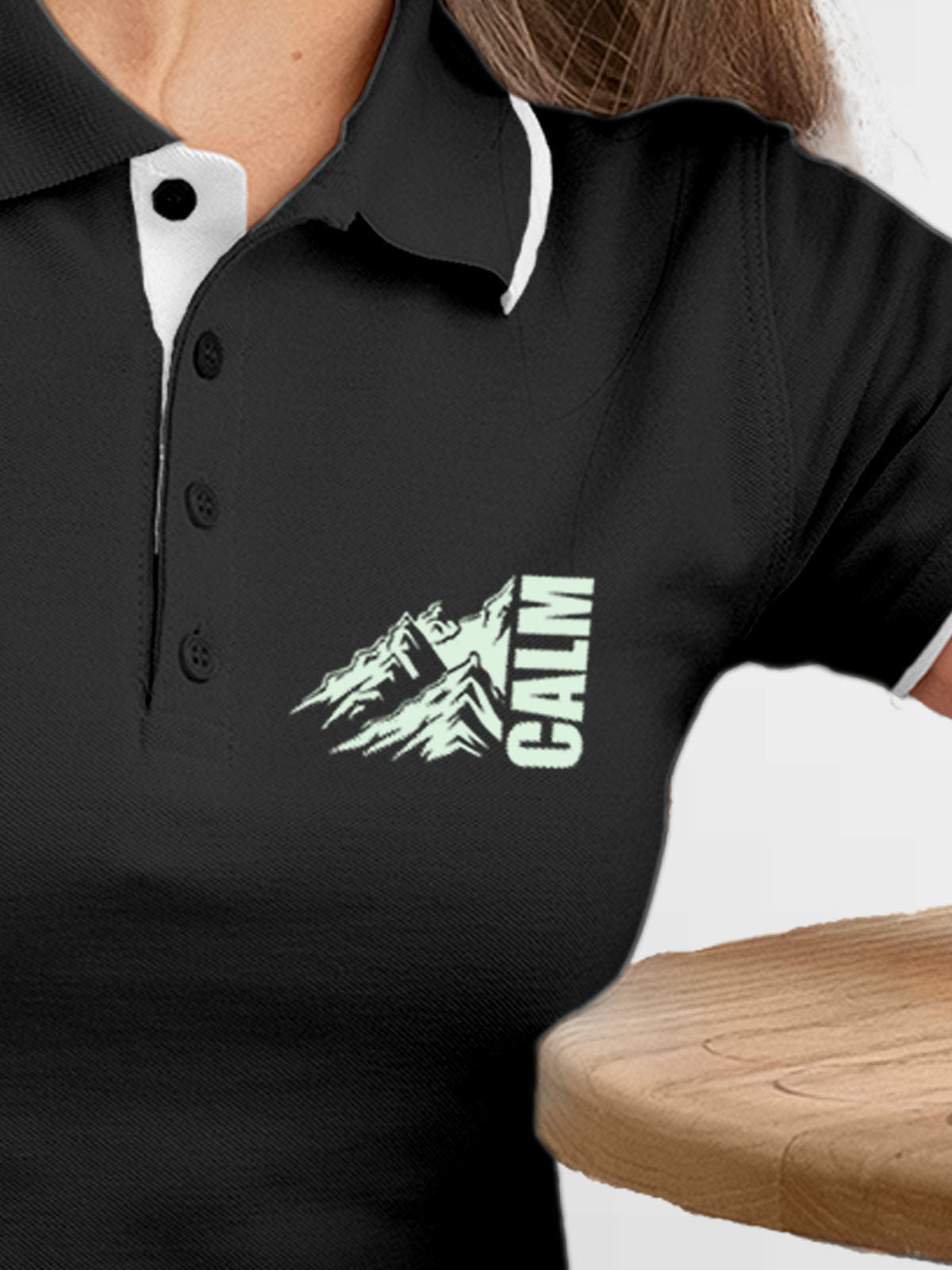 Close up of 'Calm' design on Women's Dark Grey Polo T-shirt, highlighting intricate details and vibrant print.