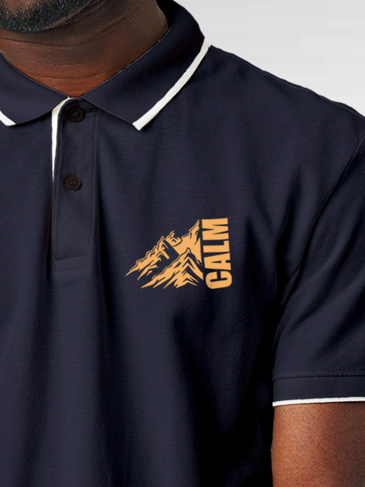 Close up of 'Calm' design on Men's Navy Blue Polo T-shirt, highlighting intricate details and vibrant print.