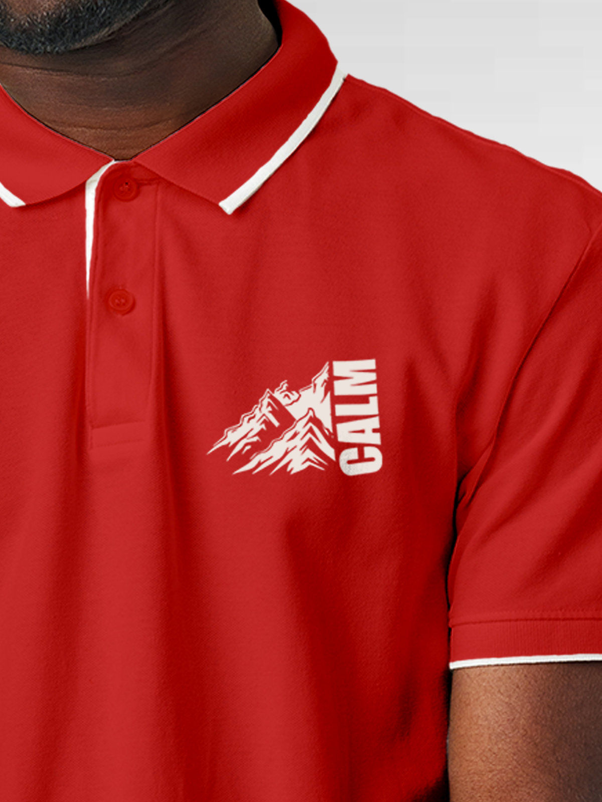Close up of 'Calm' design on Men's Red Polo T-shirt, highlighting intricate details and vibrant print.