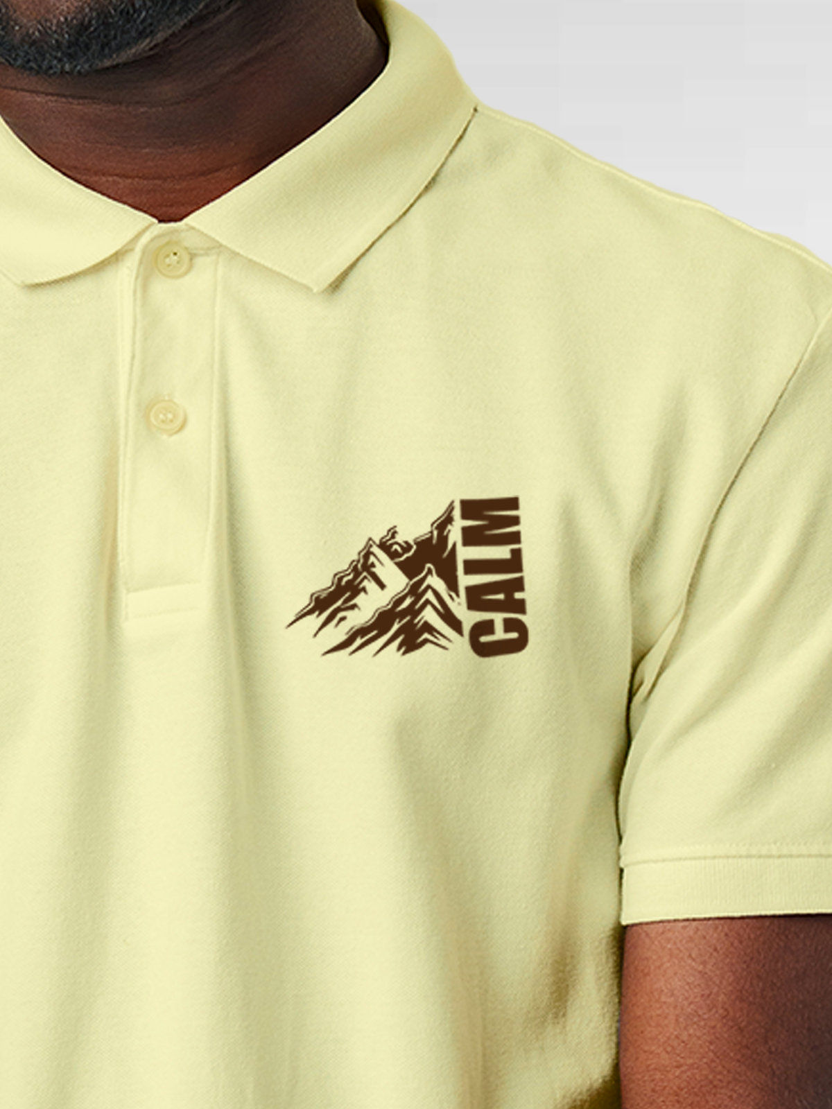Close up of 'Calm' design on Men's Yellow Polo T-shirt, highlighting intricate details and vibrant print.