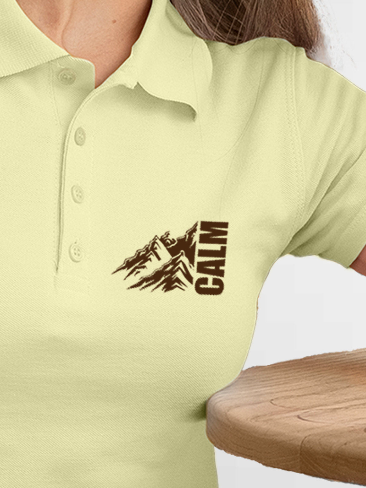 Close up of 'Calm' design on Women's Yellow Polo T-shirt, highlighting intricate details and vibrant print.