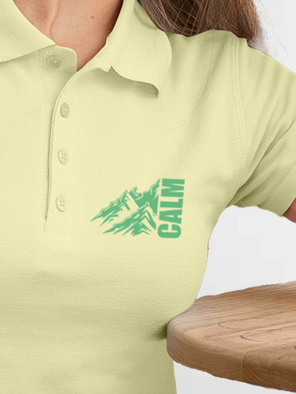Close up of 'Calm' design on Women's Yellow Polo T-shirt, highlighting intricate details and vibrant print.