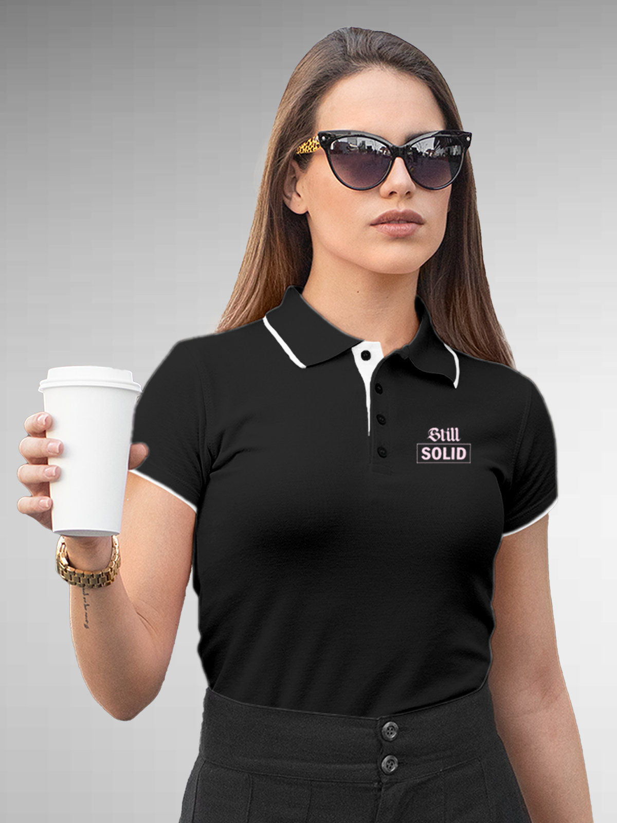 Model wearing Women's Dark Grey Polo T-shirt with 'Still Solid' design, offering effortless style and premium comfort