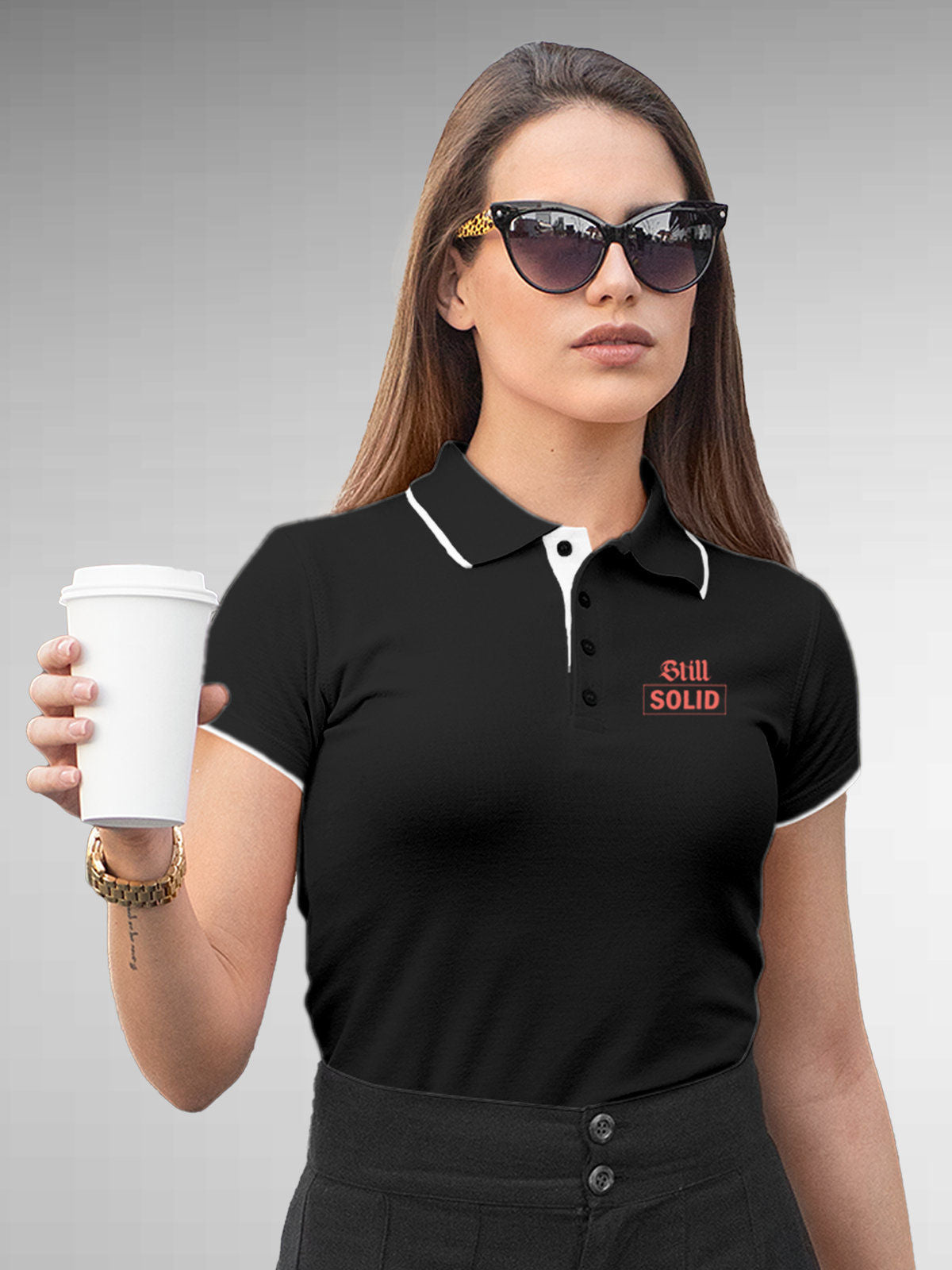 Model wearing Women's Dark Grey Polo T-shirt with 'Still Solid' design, offering effortless style and premium comfort
