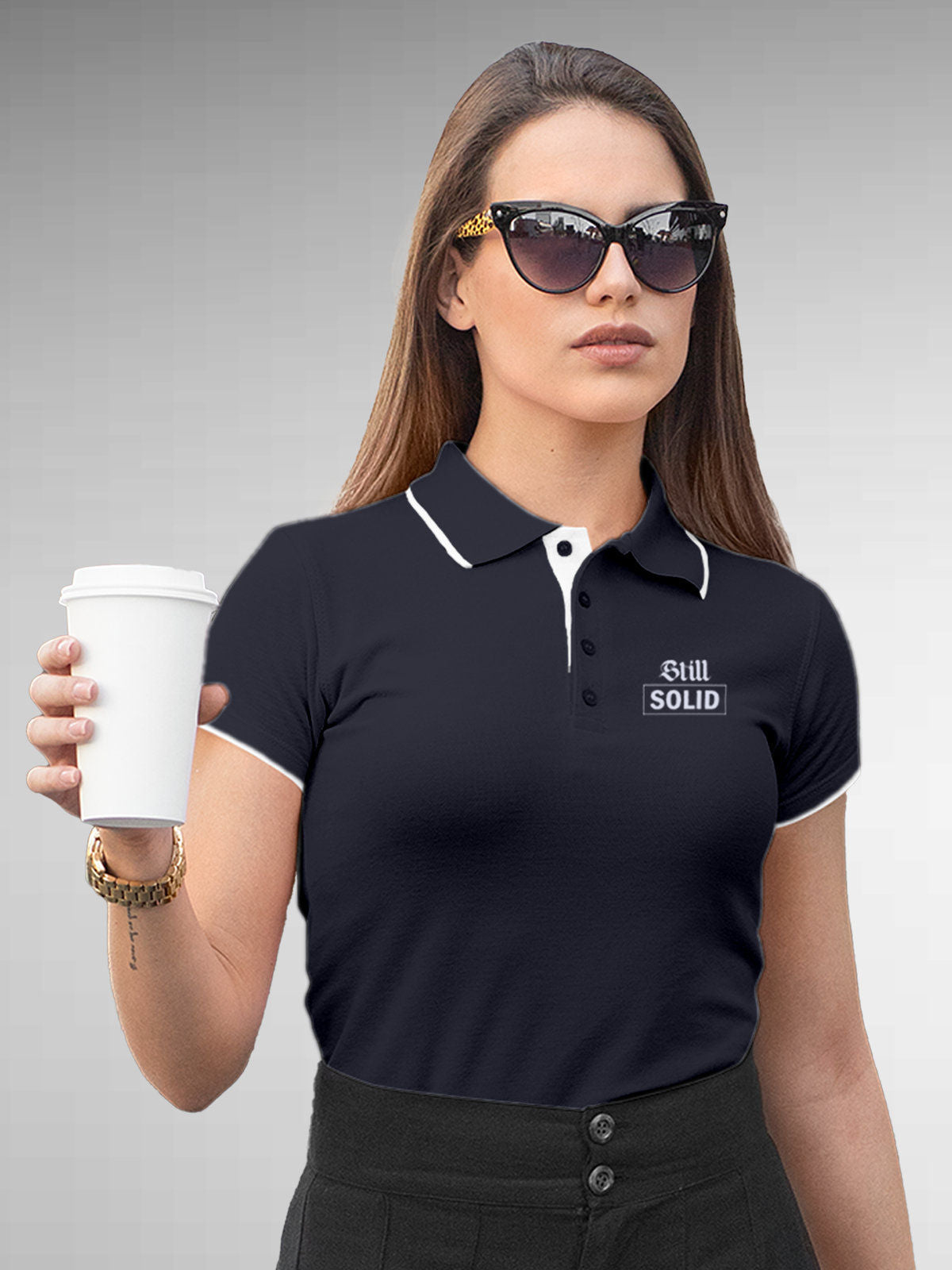 Model wearing Women's Navy Blue Polo T-shirt with 'Still Solid' design, offering effortless style and premium comfort
