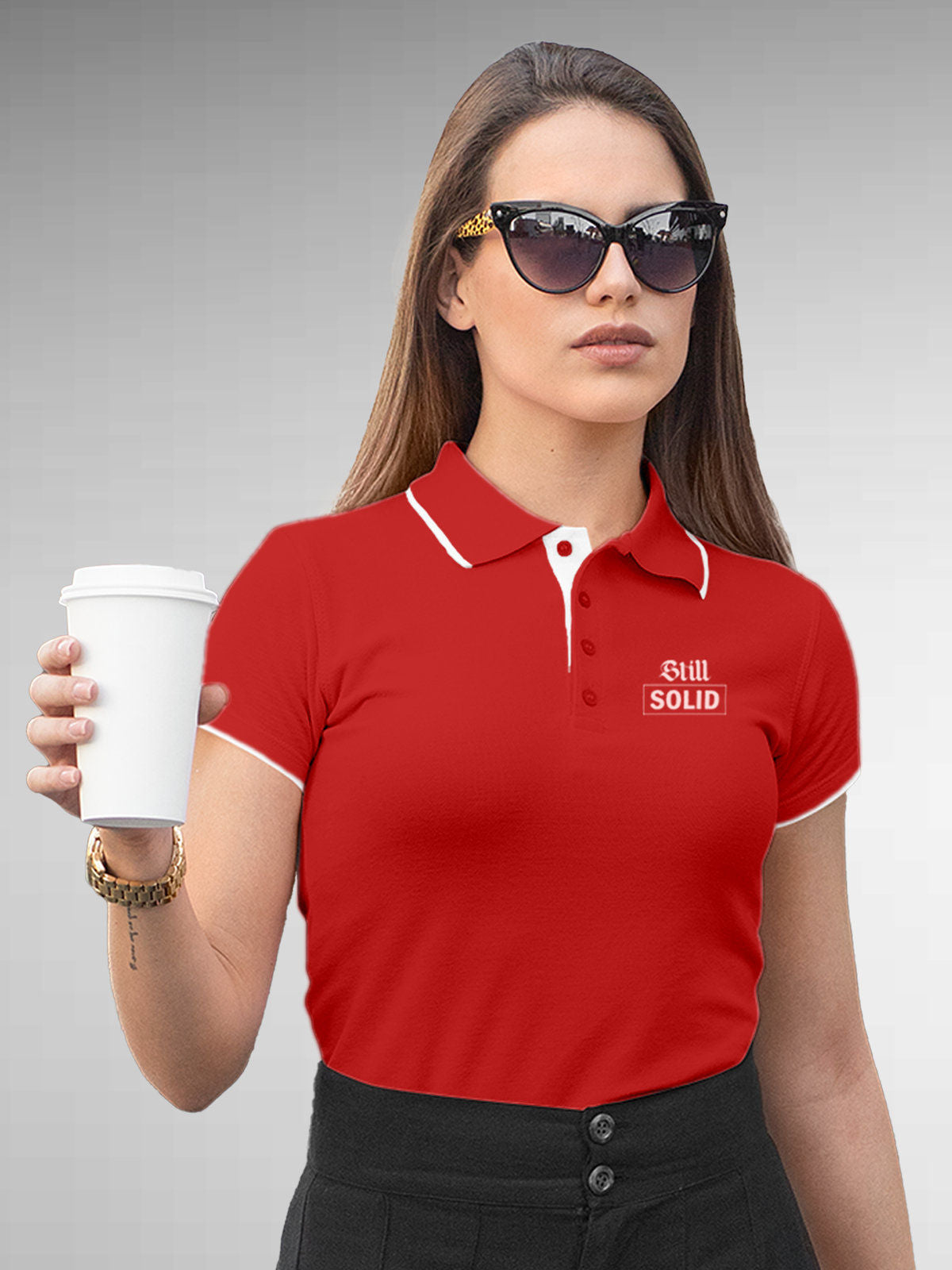 Model wearing Women's Red Polo T-shirt with 'Still Solid' design, offering effortless style and premium comfort