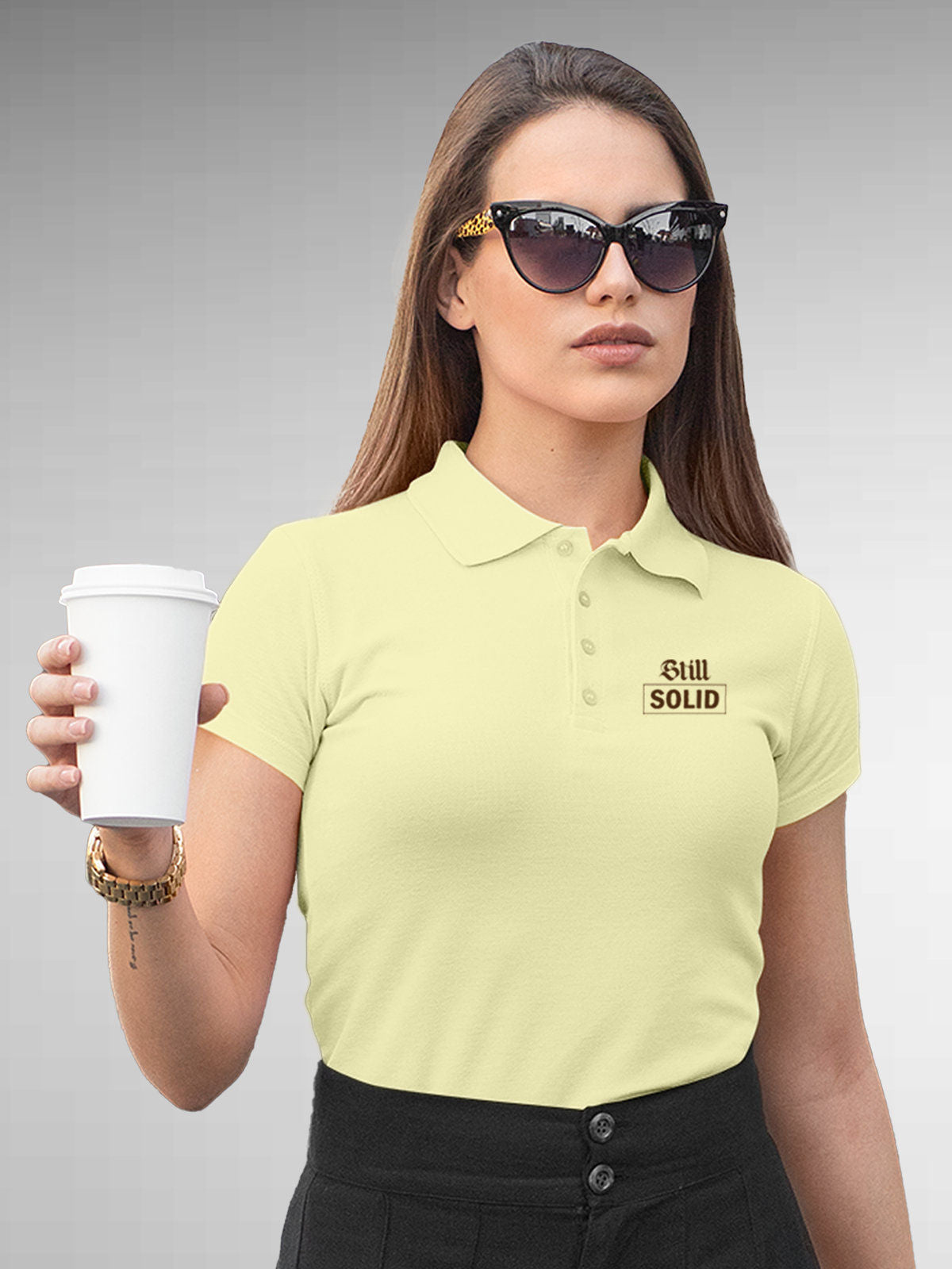 Model wearing Women's Yellow Polo T-shirt with 'Still Solid' design, offering effortless style and premium comfort